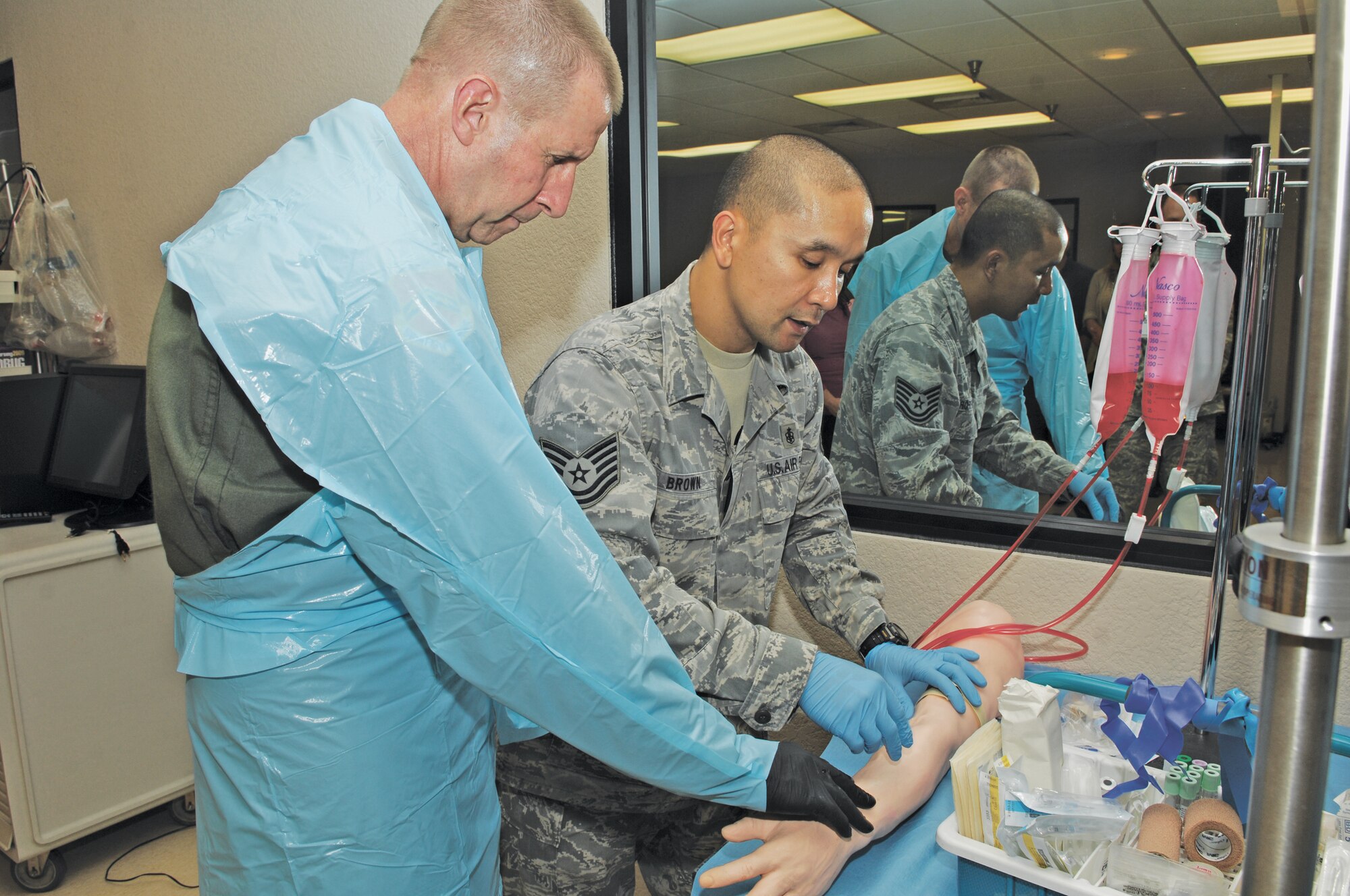 Tech. Sgt. Ovendalin Brown, 366th Medical Group education and training NCO-in charge, show Maj. Gen. Mark Solo, 19th Air Force commander, how to start intravenous therapy on a patient simulator arm 28 Mar., during his visit to Luke Air Force Base.  General Solo toured the base March 28 and 29 meeting with Airmen to learn about the wing mission and help address issues.  (U.S. Air Force photo/Staff Sgt. Steve Nabor)