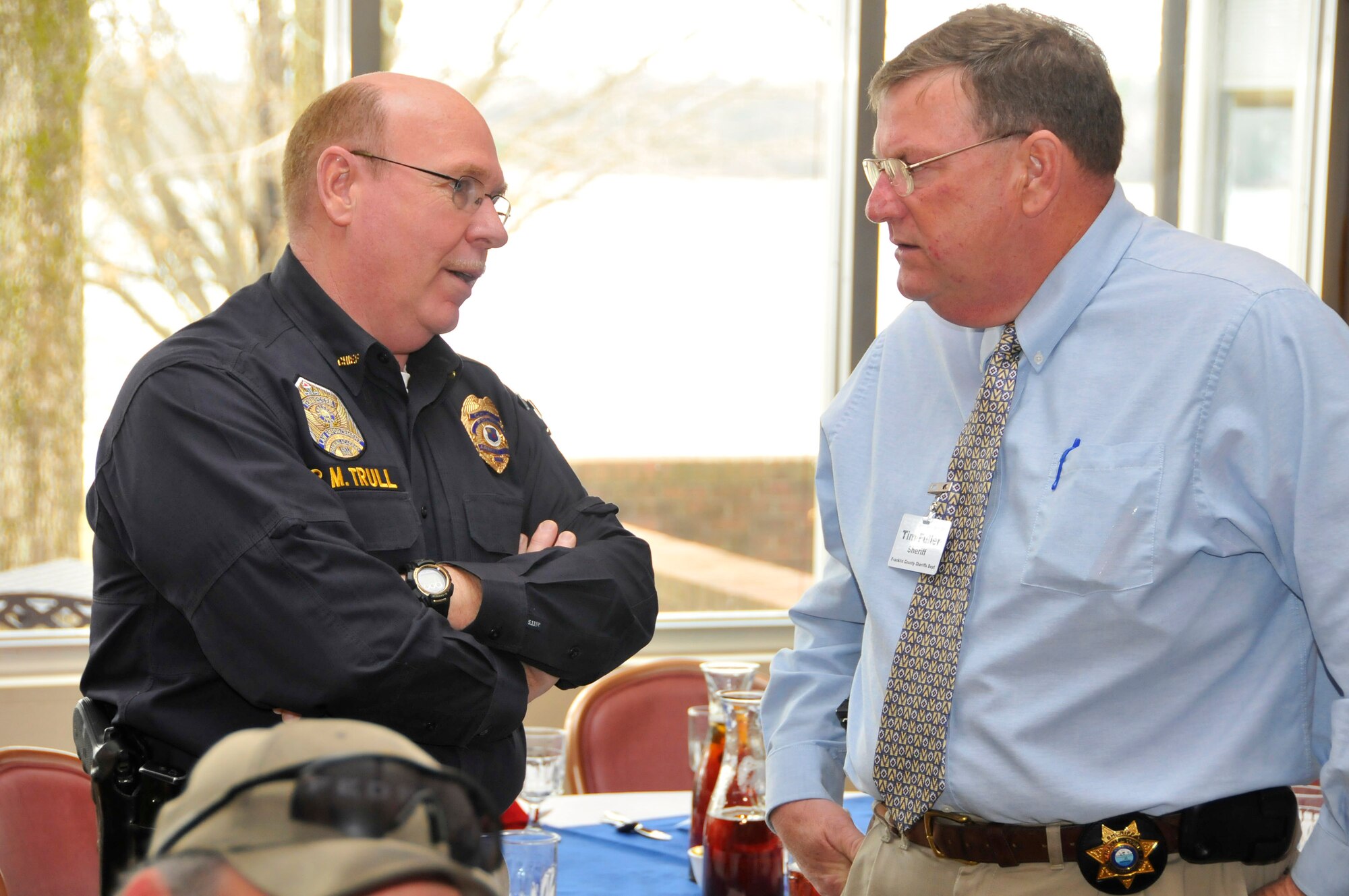 From left, AEDC Police Chief Rick Trull confers with Franklin County Sherriff Tim Fuller about issues affecting all local law enforcement agencies during the recent annual “working luncheon” held at the Arnold Lakeside Center. (Photo by Rick Goodfriend)