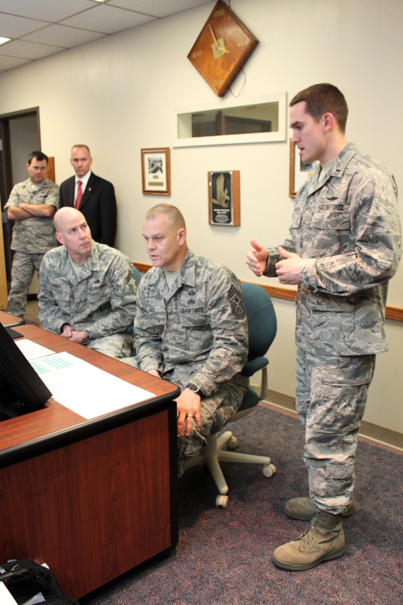1st Lt. Stephen Lawson, the Air Force Personnel Center's force development chief, explains the new enlisted development tool to Chief Master Sgt. of the Air Force James Roy and Chief Master Sgt. Ray Guest, the Air Force's nuclear weapons career field manager, March 31. (U.S. Air Force photo/Tech. Sgt. Steve Grever)