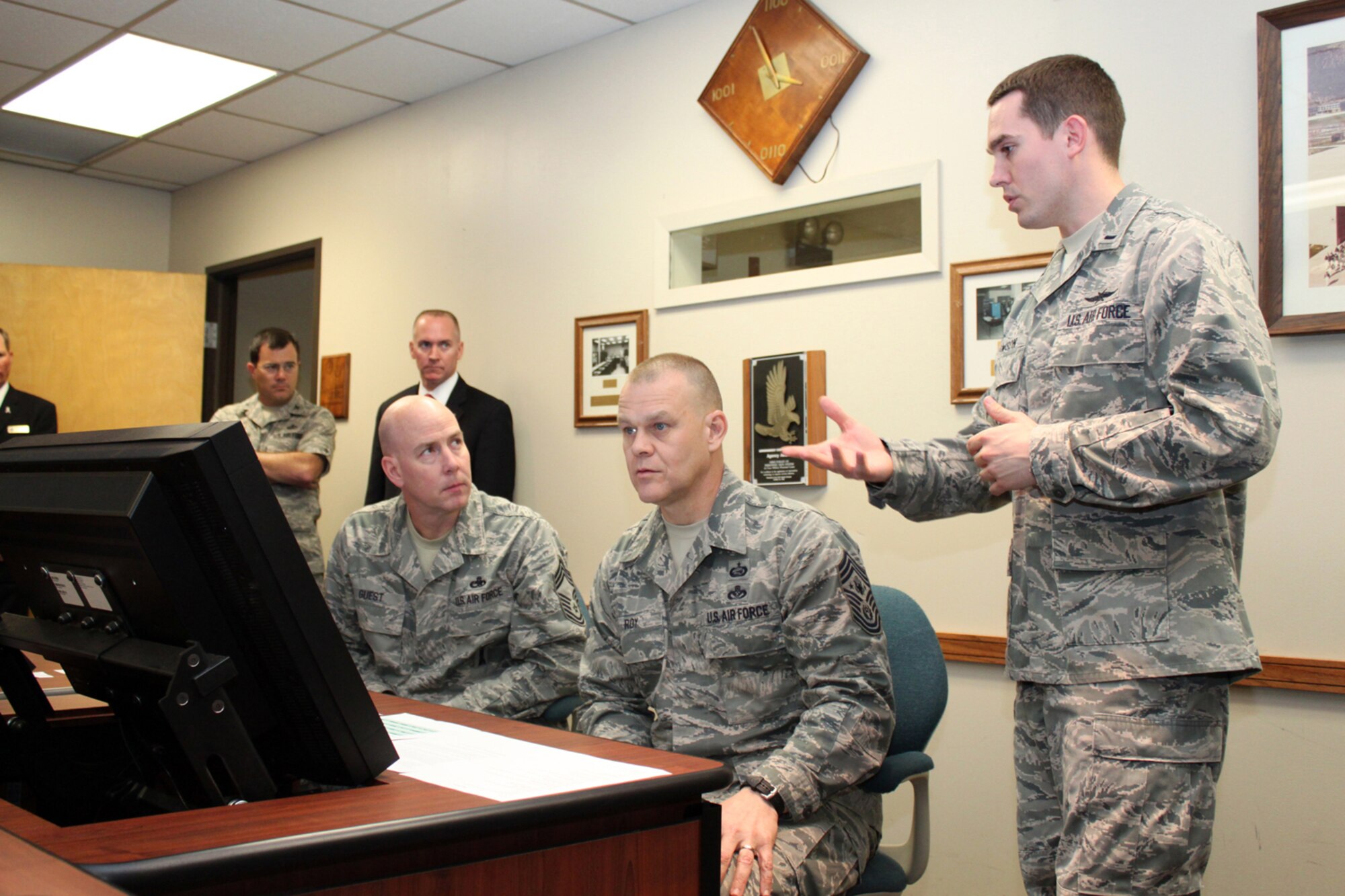 1st Lt. Stephen Lawson, the Air Force Personnel Center's force development chief, explains the new enlisted development tool to Chief Master Sgt. of the Air Force James Roy and Chief Master Sgt. Ray Guest, the Air Force's nuclear weapons career field manager, March 31. (U.S. Air Force photo/Tech. Sgt. Steve Grever)
