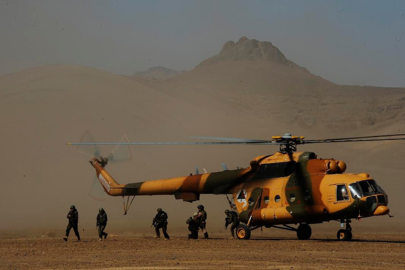Afghan National Army commandos exit an Afghan Air Force Mi-17 helicopter during a joint air assault exercise at Shindand Air Base, Afghanistan, Feb. 8, 2011.  The exercise provides valuable training for both the pilots and the commandos, and ensures they have the knowledge to conduct their own operations in the future.  (U.S. Air Force Photo/Staff Sgt. Eric Harris) (RELEASED)