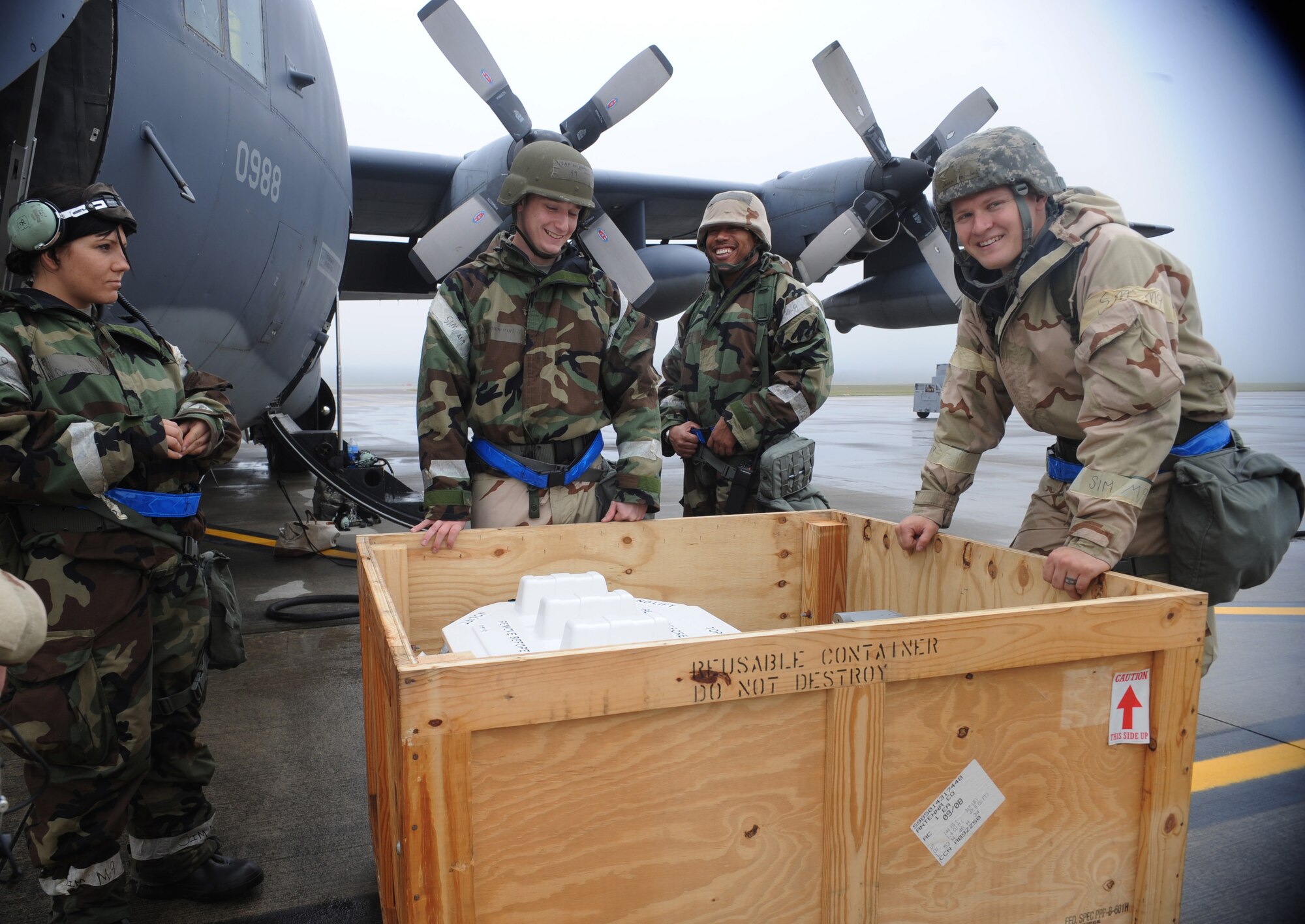Airmen from the 723rd Aircraft Maintenance Unit laugh while working on a HC-130P Combat King during an operational readiness exercise March 31 at Moody Air Force, Ga. These Airmen installed a new radar system on the aircraft that can provide weather information and ground mapping. (U.S. Air Force photo/Airman 1st Class Douglas Ellis)(RELEASED)