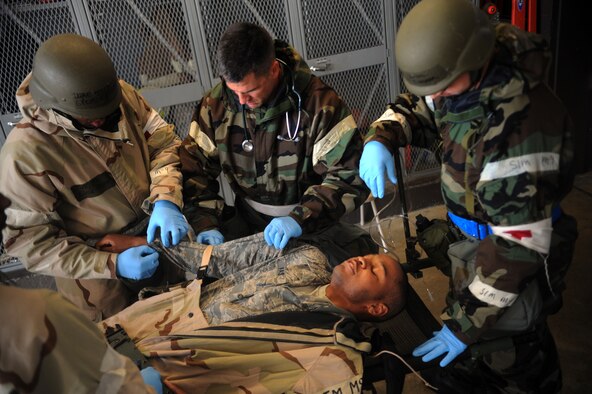 Members of the 23rd Medical Group care for a contaminated victim during an operational readiness exercise March 30 at Moody Air Force, Ga. Not only does the 23rd MDG provide air medical evacuations downrange, it also has personnel who promote spiritual and mental health. (U.S. Air Force photo/Airman 1st Class Douglas Ellis)(RELEASED)