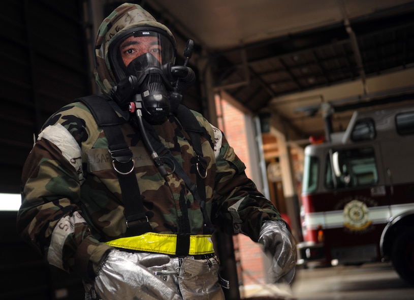 Senior Airman Serafin Rosa, 23rd Civil Engineer Squadron driver operator, dawns into mission oriented protective posture during an operational readiness exercise March 30 at Moody Air Force, Ga. The fire emergency services flight's main mission is to keep planes in the air. (U.S. Air Force photo/Airman 1st Class Douglas Ellis)(RELEASED)