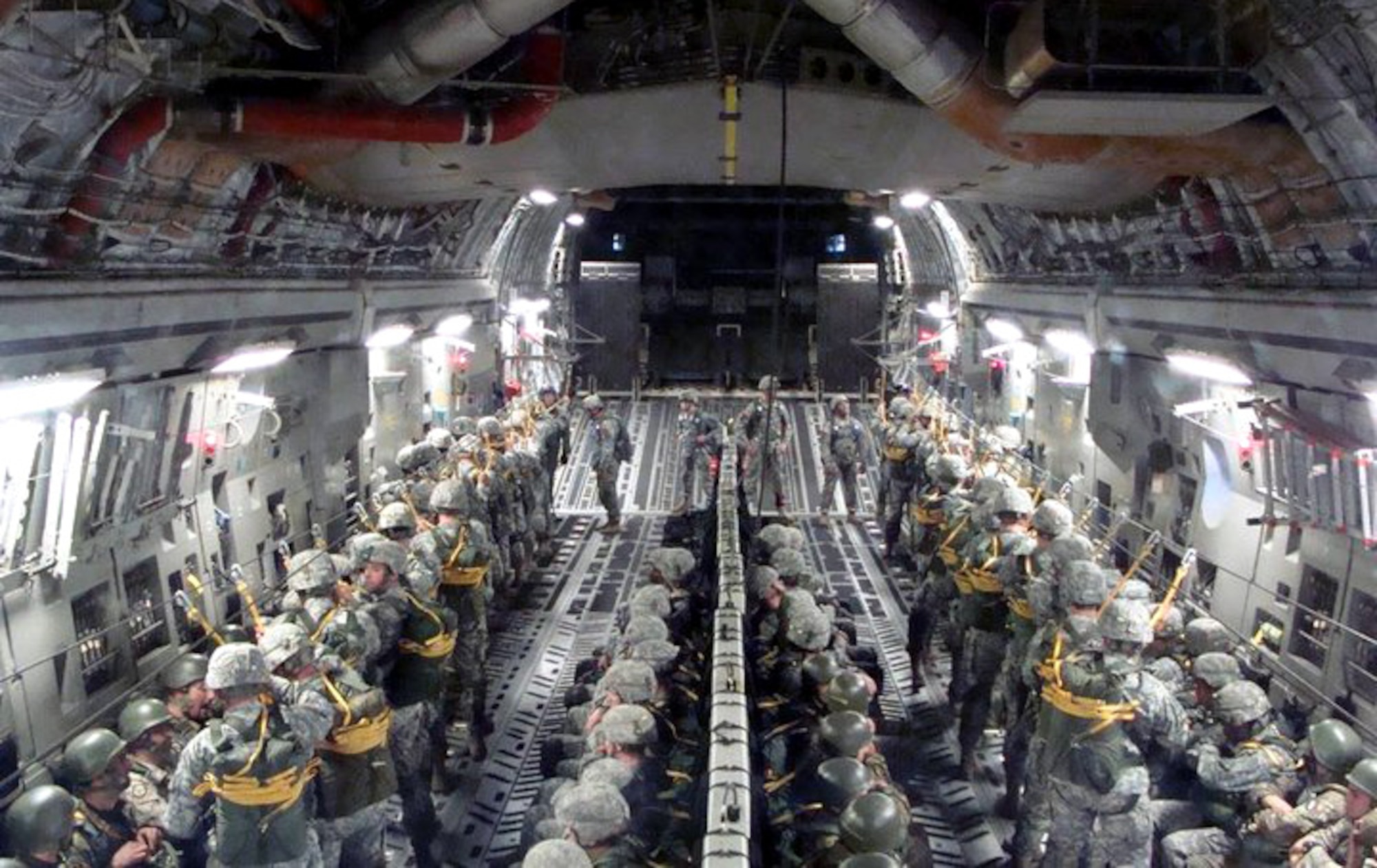AVIANO AIR BASE, Italy -- Paratroopers from the U.S. Air Force 8th Air Support Operations Squadron stationed at Aviano Air Base, Italy, the U.S. Army 173rd Airborne Brigade Combat Team stationed at U.S. Army Garrison Vicenza, Italy, and the Italian Folgore Brigade, which is equivalent to the U.S. Army Rangers, prepare for a jump from an Altus AFB C-17 Globemaster III.  All totaled, there were 59 jumps for the U.S. Air Force, 39 for the Italian army and 1,382 for the U.S. Army, amounting to 1,554 people and 413,000 pounds of cargo transported. (U.S. Air Force photo by 1st Lt. Maria Amistoso)