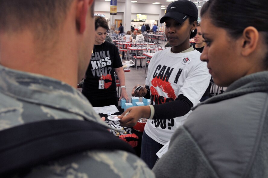 Master Sgt. Felisha Haman, Air Force Global Strike Command, hands out pins and information on sexual assault to Airmen in the base exchange on Barksdale Air Force Base, La., March 31. Events to raise awarness on sexual assault will be held throughout the month. Information on upcoming events can be found on facebook by entering Barksdale SARC in the search box.(U.S. Air Force photo/Airman 1st Class Micaiah Anthony)(RELEASED)