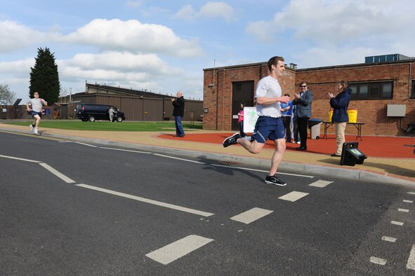 2nd Lt. Sean O’Keefe crosses the finish line first, completing the Fun Run with a time of 19:46.  The Fun Run was part of the kick-off event for Sexual Assault Awareness Month. (U.S. Air Force photo by Tech. Sgt. John Barton)