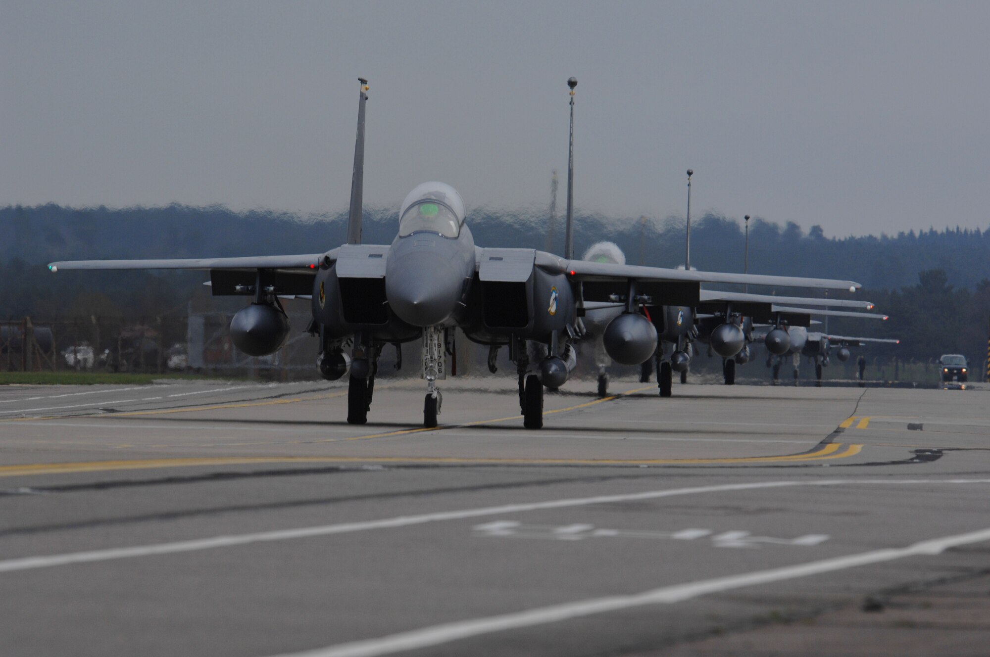 ROYAL AIR FORCE LAKENHEATH, England - A group of F-15E Strike Eagles from the 4th Fighter Wing at Seymour Johnson Air Force Base, N.C., taxi to the runway to depart RAF Lakenheath, England, March 26, 2011.  The aircraft stopped at Lakenheath on their way home from a regularly scheduled deployment to Southwest Asia. (U.S. Air Force photo by Tech. Sgt. Lee A. Osberry Jr.)