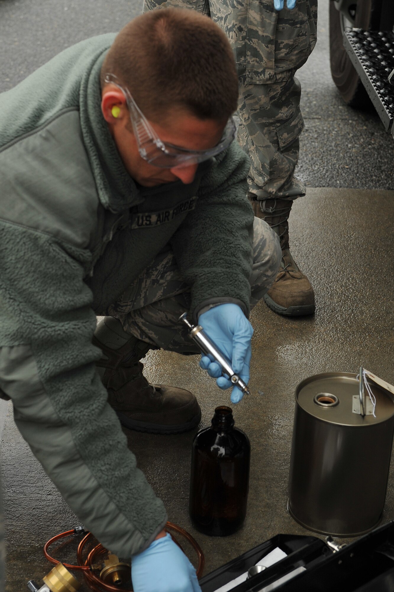 SEYMOUR JOHNSON AIR FORCE BASE, N.C. – Senior Airman David Alexander collects a fuel sample here, March 31, 2011. Airman Alexander samples jet petroleum fuel before mixing it with hydro-treated renewable jet fuel. Airman Alexander, 4th Logistic Readiness Squadron fuel lab technician, is a native of Vacaville, Calif. (U.S. Air Force photo/Senior Airman Whitney Lambert) (RELEASED)
