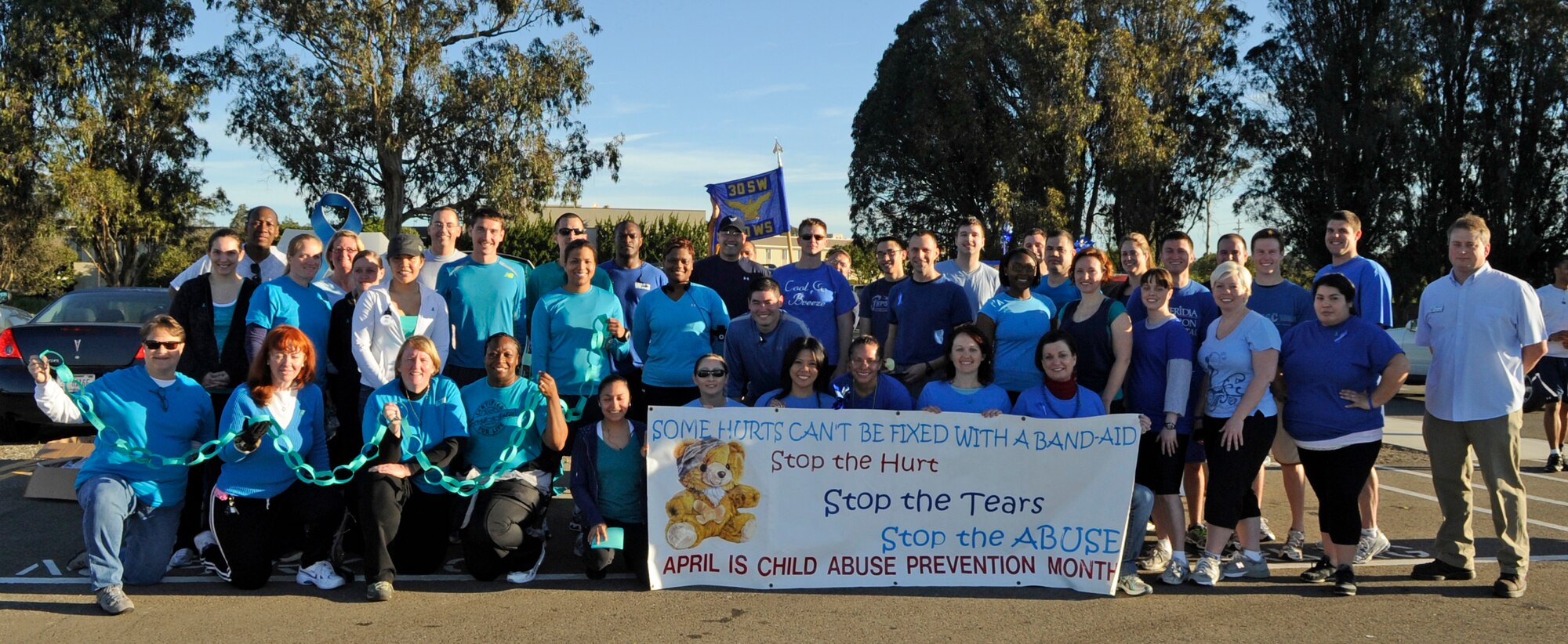 VANDENBERG AIR FORCE BASE, Calif. – Supporters of the Sexual Assault Response Coordinator and Child Abuse Prevention pose for a photo after the Fit-to-Fight Run at the parade grounds here Thursday, March 31, 2011. Participants of the run were authorized to wear blue T-shirts in support of Child Abuse Prevention Month or teal T-shirts in support of Sexual Assault Awareness Month. (U.S. Air Force photo/Senior Airman Lael Huss)