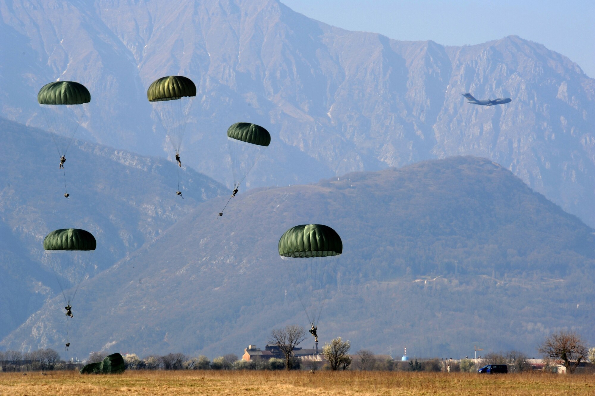 Members from the U.S. Army 173rd Airborne Brigade Combat Team conducts combat jump operations from a C-17 Globemaster III during a joint coalition training exercise March 23, 2011, at Aviano Air Base, Italy. More than 1,400 personnel from the 173rd ABCT, the 8th Air Support Operation Squadron and Italian Army paratroopers participated in the weeklong event. (U.S. Air Force photo/Staff Sgt. Nadine Y. Barclay) 
