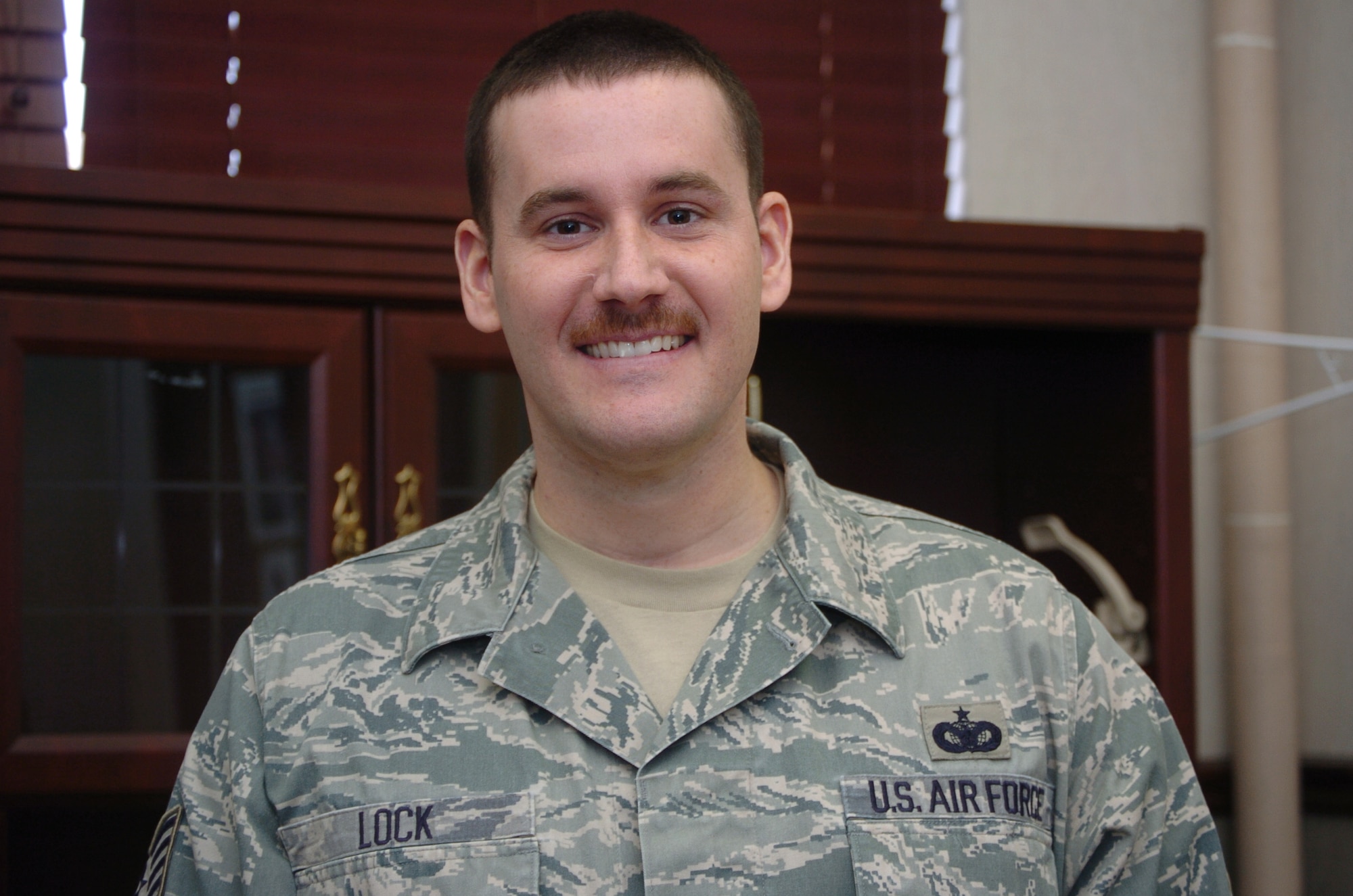 Tech. Sgt. Roy Lock, 75th Security Forces Squadron, enjoys the humor Mustache March brings to the workplace. He participates in this tradition every year. (U.S Air Force photo by Airman 1st Class Melissa Dearstone)