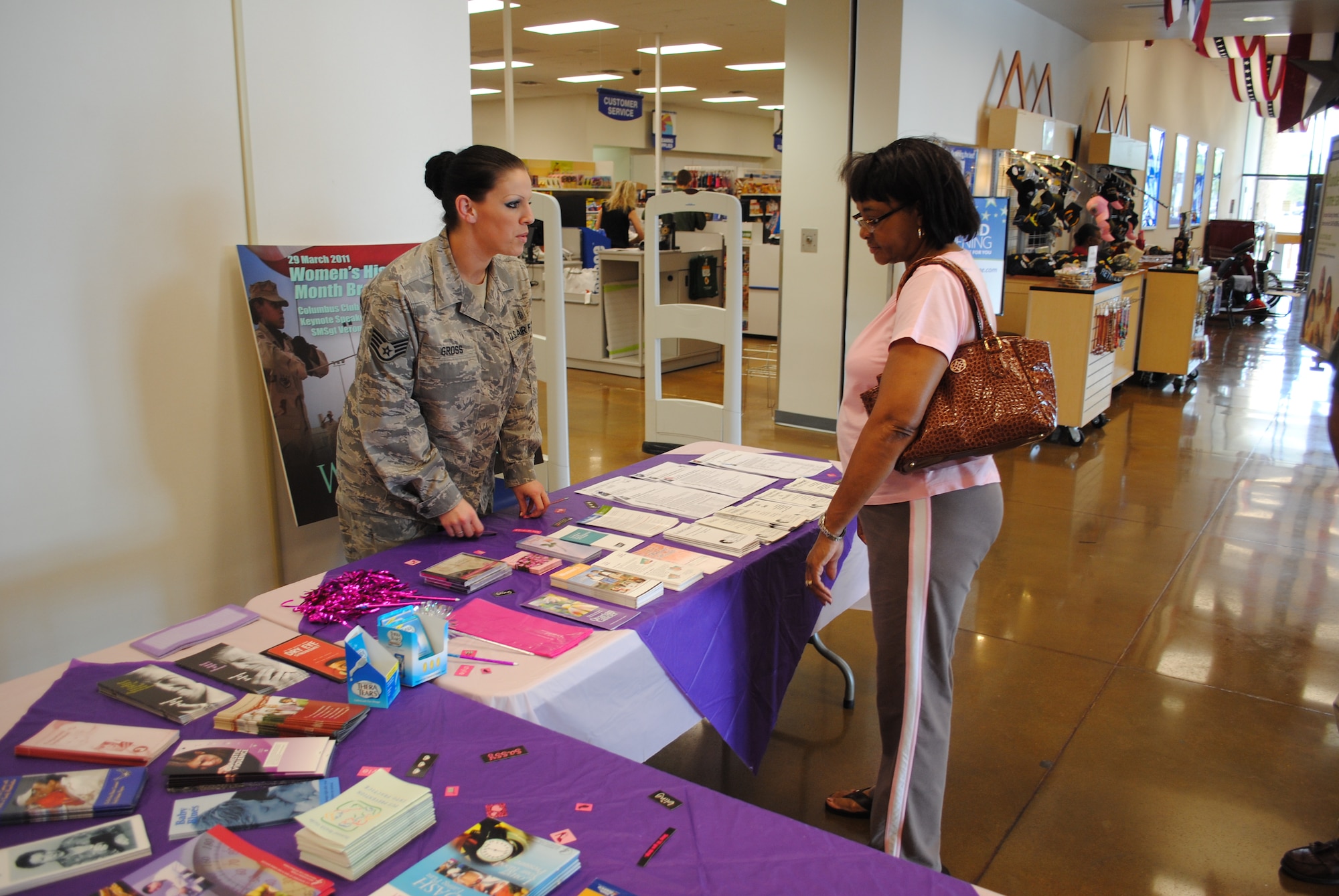 Staff Sgt. Ashley Gross, 14th Medical Group, helps an interested visitor at the information table during the second Women’s Health Fair at the base Exchange. Pamphlets and samples were available to help raise awareness about women’s health. (U.S. Air Force photo/2nd Lt. Brionna Ruff)