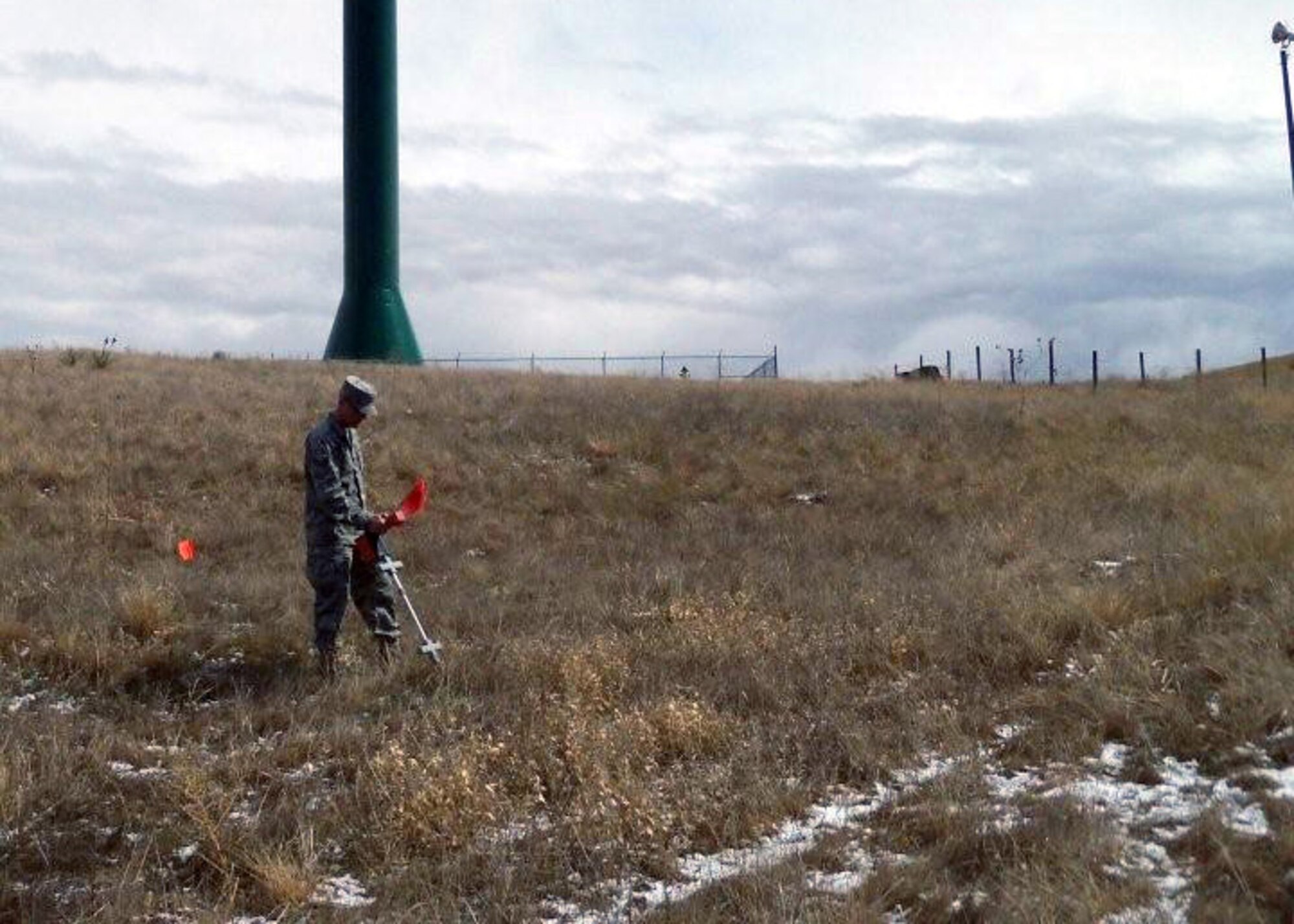 Senior Airman Toby Harter, 90th Missile Maintenance Squadron, marks the location of underground cable in the missile field. (U.S. Air Force photo by Blaze Lipowski)
