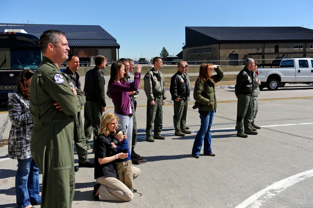 Airmen, families and friends await the arrival of the air crew that participated in Operation Odyssey Dawn, S.D., March 30, 2011. Upon arrival at Ellsworth Air Force Base, the aircrews were honored by salutes from the 28th Bomb Wing Airmen in formation on the flight line. (U.S. Air Force photo/Senior Airman Adam Grant)