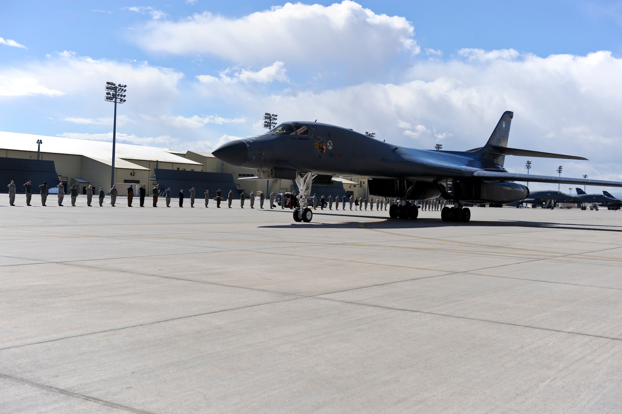 Airmen from the 28th Bomb Wing line up to greet the return of two B-1 Lancers at Ellsworth Air Force Base, S.D., March 30, 2011.  Airmen on the flight line rendered salutes to honor the aircrews of the 34th Bomb Squadron who flew during Operation Odyssey Dawn. (U.S. Air Force photo/Senior Airman Adam Grant)
