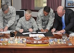 From left, Col. Patrick Vetter, 37th Training Wing vice commander; Col. William H. Mott V, 37th TRW commander; Chief Master Sgt. Jay Simon, 37th TRW command chief; and Steve Arrington, 37th TRW director of staff, fill out Air Force Assistance Fund pledge forms March 29. Fundraising for the Lackland Air Force Assistance Fund six-week campaign began March 28 with a goal of raising $267,819 for the four charitable affiliates under the AFAF umbrella. (U.S. Air Force photo/Alan Boedeker)