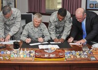 From left, Col. Patrick Vetter, 37th Training Wing vice commander; Col. William H. Mott V, 37th TRW commander; Chief Master Sgt. Jay Simon, 37th TRW command chief; and Steve Arrington, 37th TRW director of staff, fill out Air Force Assistance Fund pledge forms March 29. Fundraising for the Lackland Air Force Assistance Fund six-week campaign began March 28 with a goal of raising $267,819 for the four charitable affiliates under the AFAF umbrella. (U.S. Air Force photo/Alan Boedeker)