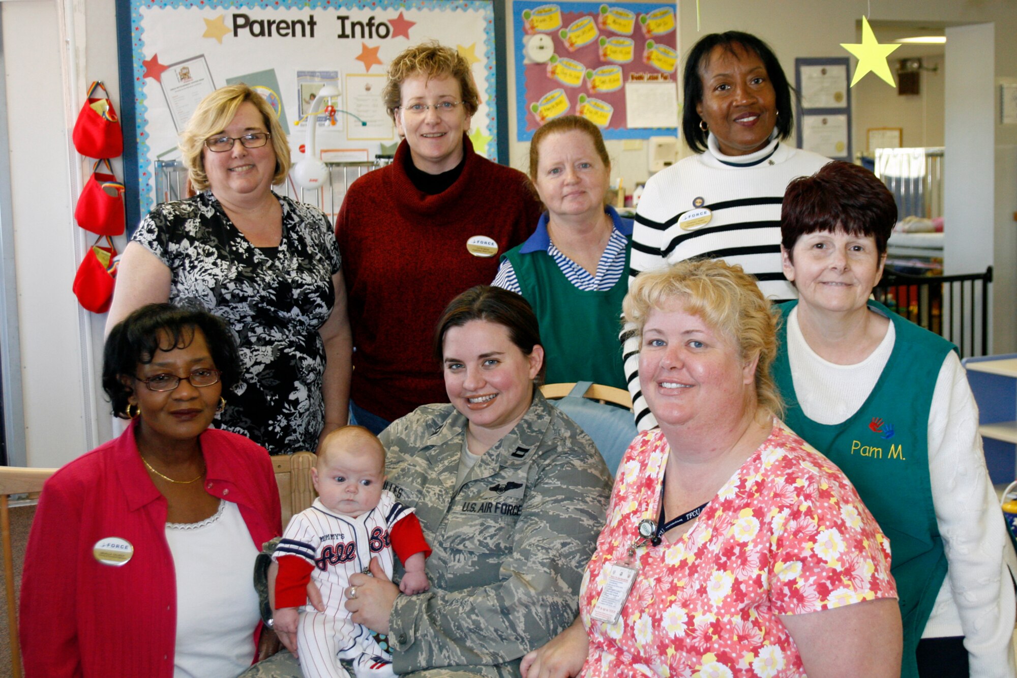Child Development Center staff members welcome 10-week-old Blake Polles and his mother Capt. Diana Polles back to the center March 24. Pictured are, back row from left, from bottom Left to center: Nessa McCarty, Caterina Mann, Carolyn Madden, Carol Jones and Pam Marlow; front, Drusilla Calhoun, Blake, Captain Polles and Robyn Lester. (Air Force photo by Becky Pillifant)