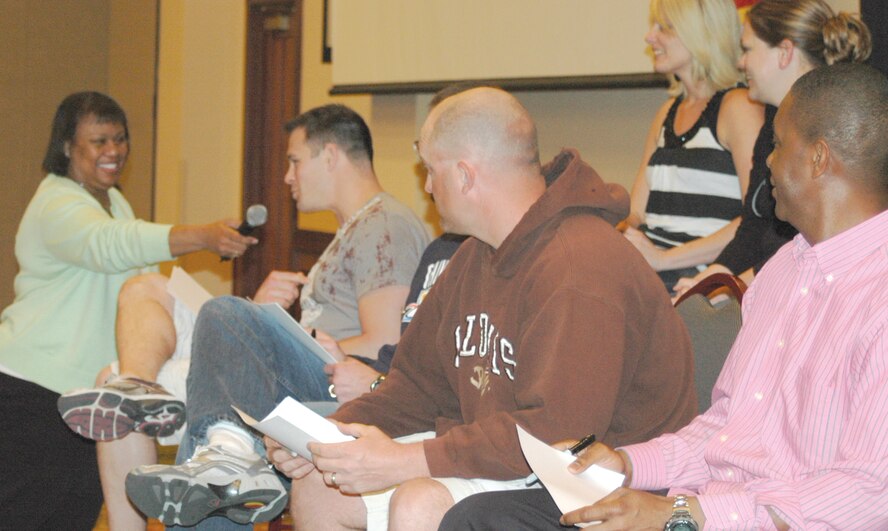 Lori Johnson-Vegas, wife of Oklahoma City Air Logistics Center Command Chief Master Sgt. Kevin Vegas, gets an answer from Matthew Meadows during the “Not So Newlywed” game at the Pre-Deployment Retreat March 26. (Air Force photo by Nicole Turner)
