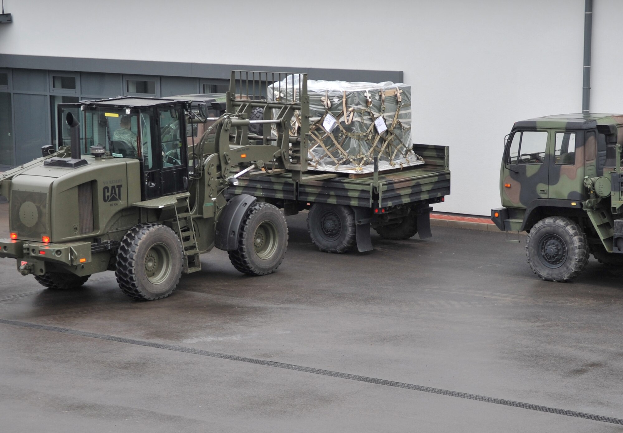 U.S. Air Force Airman 1st Class Philip Smouse, 86th Logistics Readiness Squadron air transportation, unloads cargo for an in-check in support of Operation Unified Protector, Ramstein Air Base, Germany, April 1, 2011. Unified Protector is a NATO-led operation in Libya to protect civilians and civilian-populated areas under threat of attack. (U.S. Air Force photo by Senior Airman Caleb Pierce)