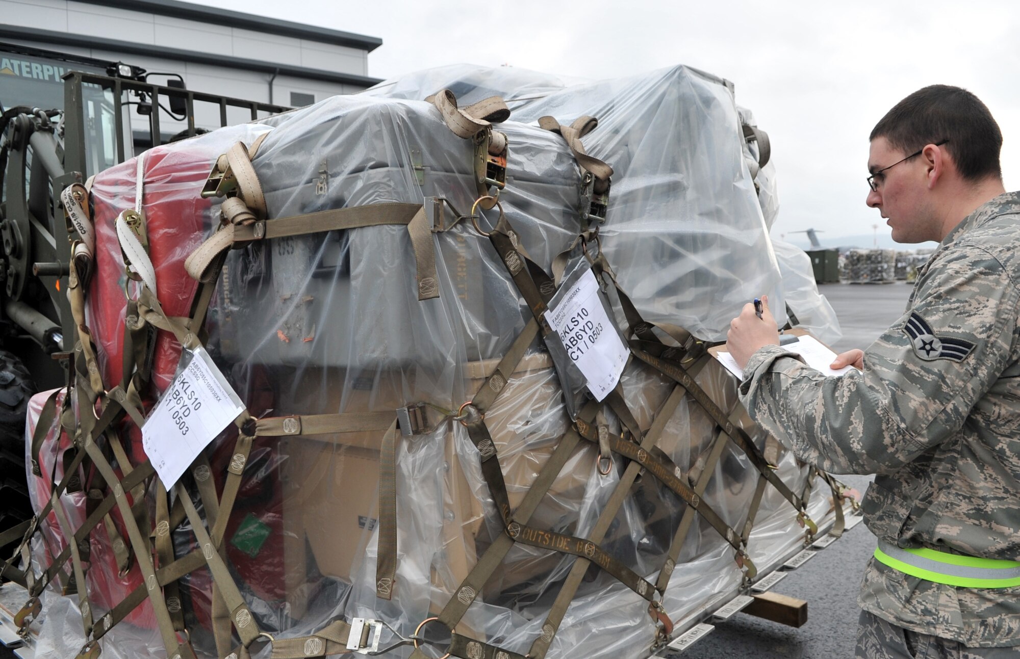 U.S. Air Force Senior Airman Justin Burger, 86th Logistics Readiness Squadron combat readiness technician, performs an in-check for cargo in support of Operation Unified Protector, Ramstein Air Base, Germany, April 1, 2011. Unified Protector is a NATO-led operation in Libya to protect civilians and civilian-populated areas under threat of attack. (U.S. Air Force photo by Senior Airman Caleb Pierce)