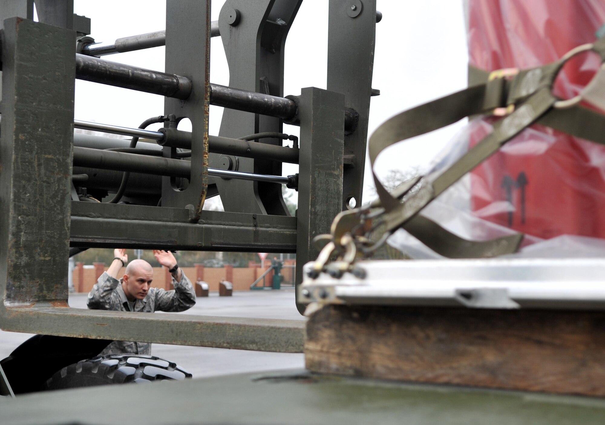 U.S. Air Force Staff Sgt. Christopher Abbott, 86th Logistics Readiness Squadron combat readiness technician, directs a forklift during an in-check of cargo for a mission in support of Operation Unified Protector, Ramstein Air Base, Germany, April 1, 2011. Unified Protector is a NATO-led operation in Libya to protect civilians and civilian-populated areas under threat of attack. (U.S. Air Force photo by Senior Airman Caleb Pierce)