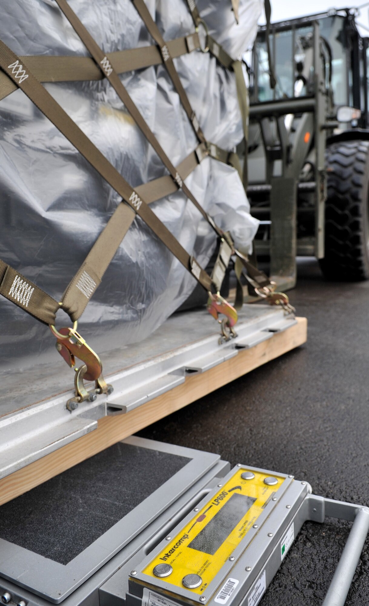The 86th Logistics Readiness Squadron combat readiness section, weighs cargo during an in-check for a mission in support of Operation Unified Protector, Ramstein Air Base, Germany, April 1, 2011. Unified Protector is a NATO-led operation in Libya to protect civilians and civilian-populated areas under threat of attack. (U.S. Air Force photo by Senior Airman Caleb Pierce)