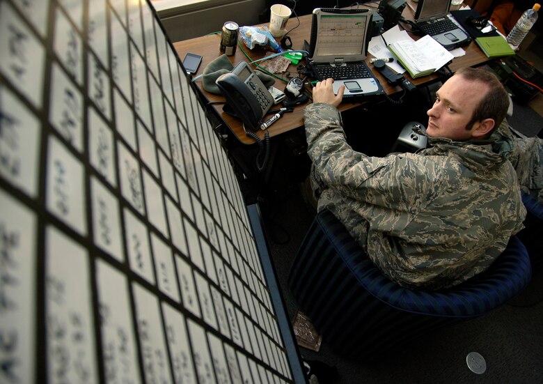 SENDAI, Japan -- Staff Sgt. Chris Sefton reviews aircraft landing schedules March 29, 2011. A team of 20 Airmen forward deployed to Sendai Airport to help the Japanese recover and rebuild in the wake of the March 11 9.0-magnitude earthquake and tsunami. Sergeant Sefton is a ground radio technician with the 320th Special Tactics Squadron, Kadena Air Base, Japan. (U.S. Air Force Photo/ Staff Sgt. J.G. Buzanowski)