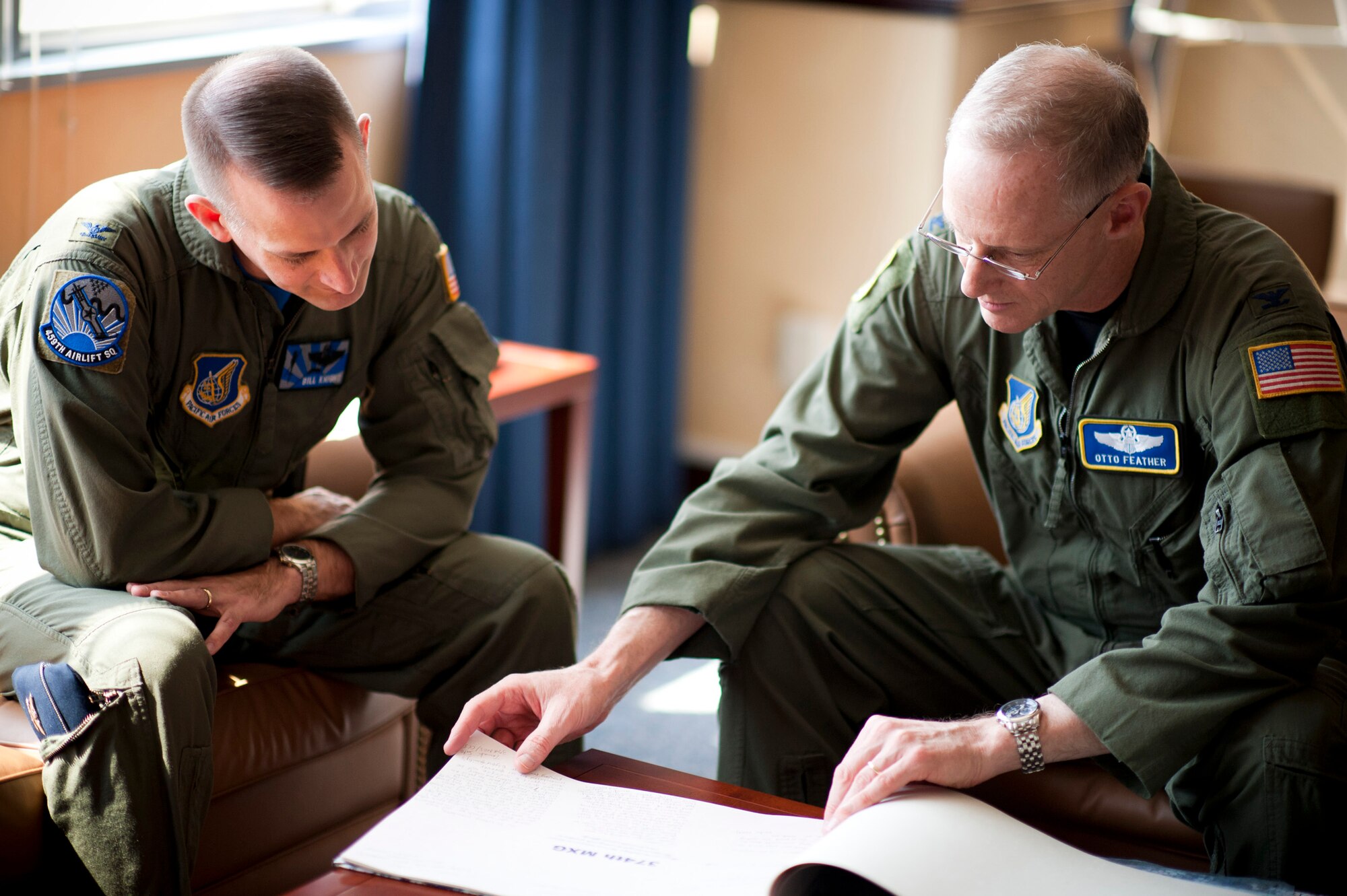 YOKOTA AIR BASE, Japan -- Col. Otto Feather (right) 374th Airlift Wing commander, and Col. Bill Knight, 374th AW vice commander, look through "Kansha no Kotoba," a book of signatures and thank-you messages from Japanese employees at Yokota here April 1. The book was created to show appreciation to members of the 374th AW for their contributions and dedication, following the earthquake and tsunami March 11. The book was given to Colonel Feather by Naomi Kumagai, Japanese Welfare Association president, during a surprise presentation. (U.S. Air Force photo/Staff Sgt. Samuel Morse)