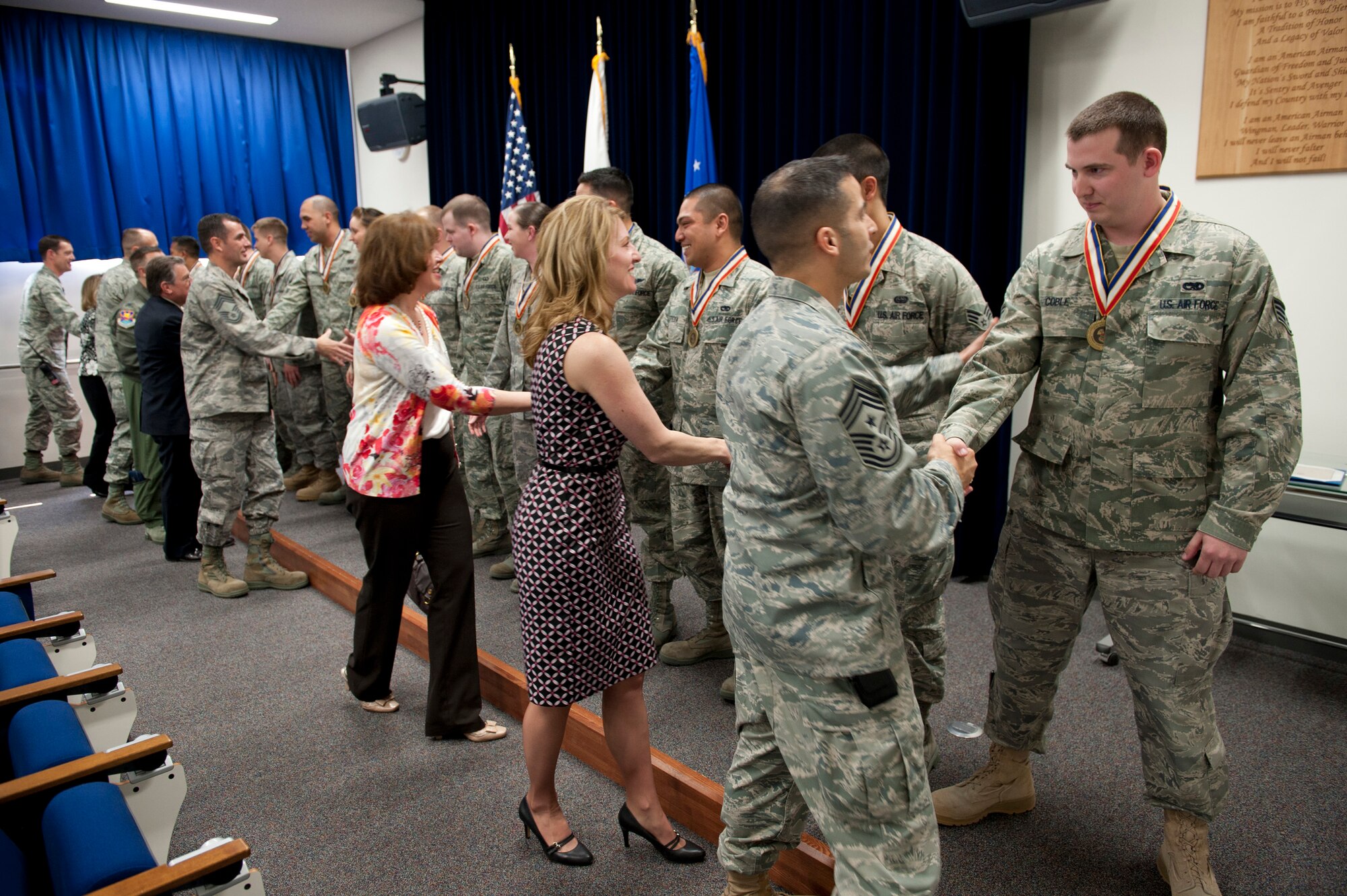 YOKOTA AIR BASE, Japan -- Yokota leadership congratulates the graduates of Airman Leadership School Class 11-C following their truncated graduation ceremony at the Professional Development Center here March 30. Due to the high demands of Operation Tomodachi, the class held a shorter graduation ceremony during the day to enable their coworkers and leadership to attend the graduation without impacting mission requirements. (U.S. Air Force photo/Staff Sgt. Samuel Morse)