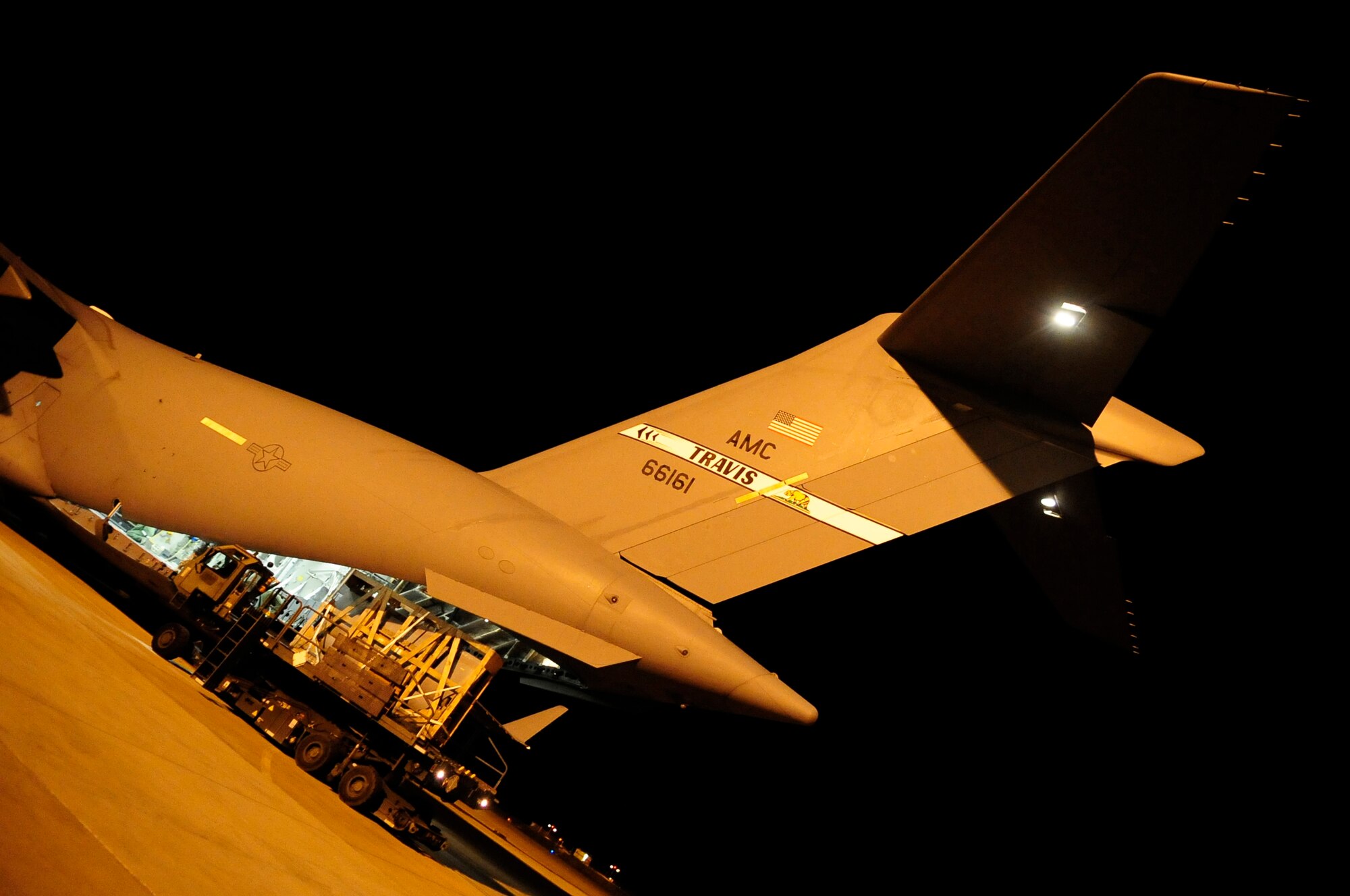 313th AIR EXPEDITIONARY WING (March 28, 2011) -- A pallet is unloaded off a C-17 Globemaster III with a 25K next generation small loader during support of Joint Task Force Odyssey Dawn. Joint Task Force Odyssey Dawn was the U.S. Africa Command task force established to provide operational and tactical command and control of U.S. military forces supporting the international response to the unrest in Libya and enforcement of United Nations Security Council Resolution (UNSCR) 1973. UNSCR 1973 authorizes all necessary measures to protect civilians in Libya under threat of attack by Gadhafi regime forces. JTF Odyssey Dawn was commanded by U.S. Navy Admiral Samuel J. Locklear III. (U.S. Air Force photo/Senior Airman Ethan Morgan)