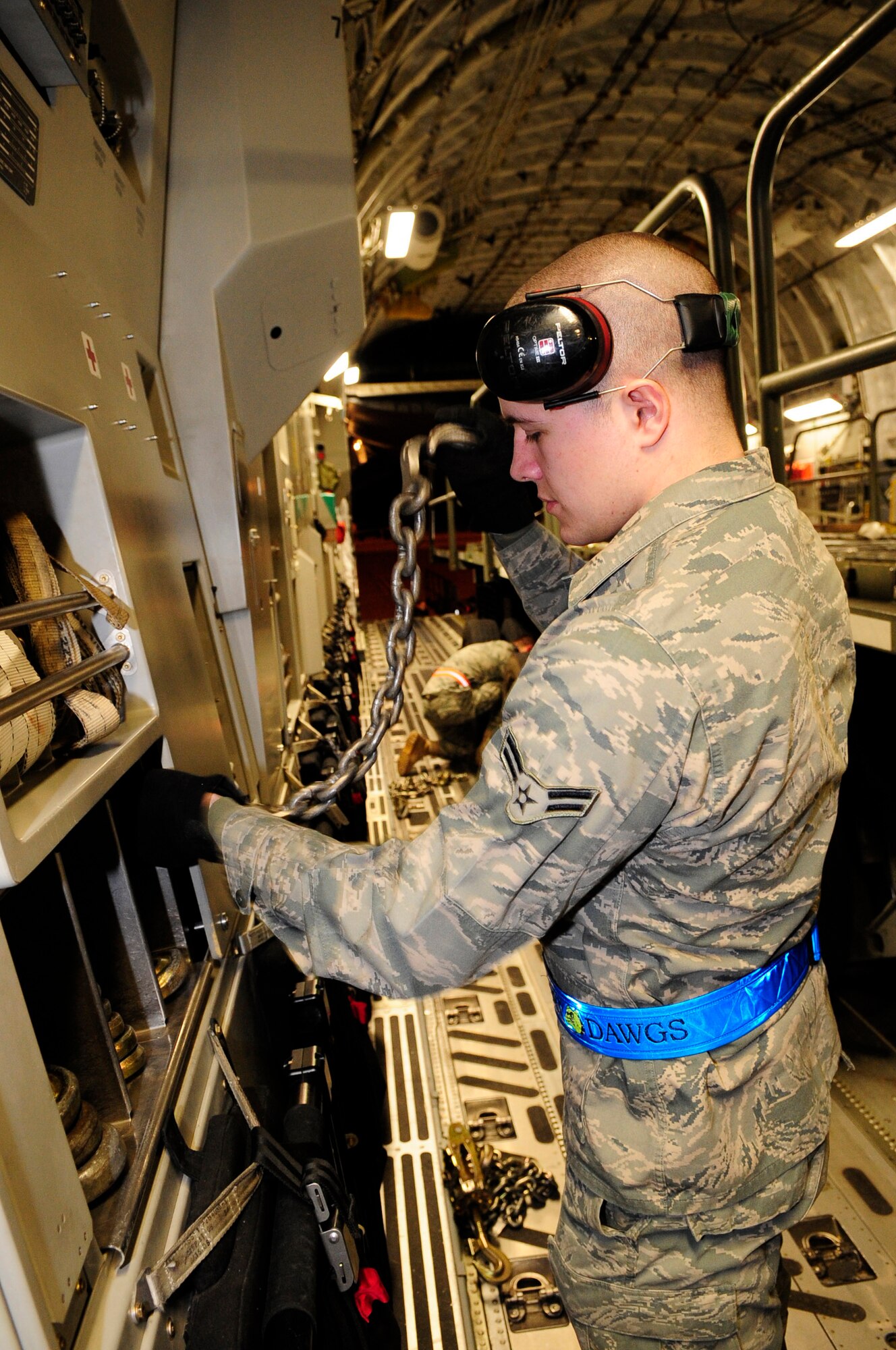 313th AIR EXPEDITIONARY WING, U.S. Forces in Europe (March 28, 2011) -- An Airman from the 721st Aerial Port Squadron, Ramstein Air Base, Germany, stows a cargo chain in a C-17 Globemaster III after preparing cargo to be unloaded here  in support of Joint Task Force Odyssey Dawn. Joint Task Force Odyssey Dawn was the U.S. Africa Command task force established to provide operational and tactical command and control of U.S. military forces supporting the international response to the unrest in Libya and enforcement of United Nations Security Council Resolution (UNSCR) 1973. UNSCR 1973 authorizes all necessary measures to protect civilians in Libya under threat of attack by Gadhafi regime forces. JTF Odyssey Dawn was commanded by U.S. Navy Admiral Samuel J. Locklear III. (U.S. Air Force photo/Senior Airman Ethan Morgan)