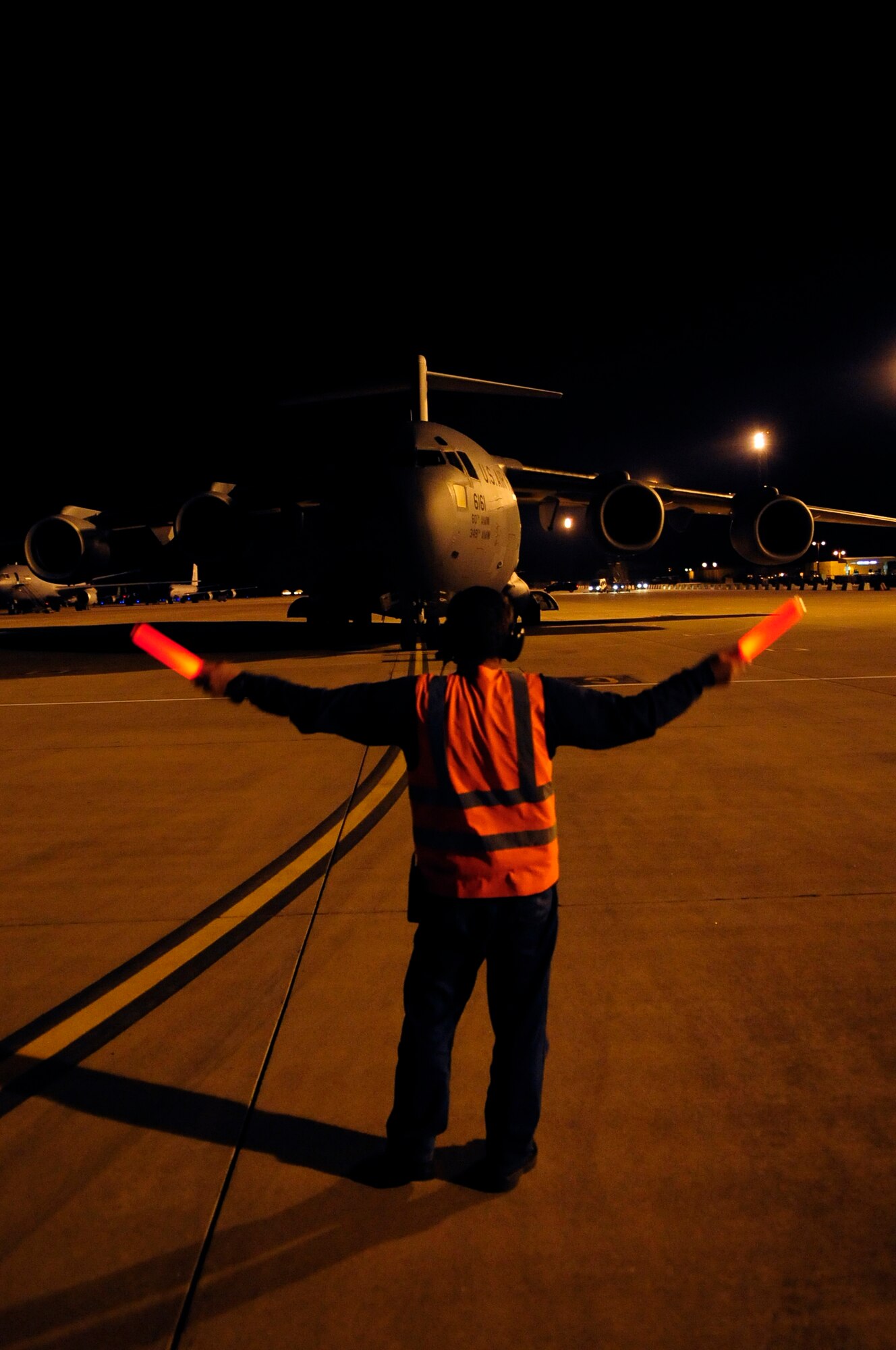 313th AIR EXPEDITIONARY WING (March 28, 2011) -- A C-17 Globemaster III from Travis Air Force Base, Calif., is marshaled into a parking spot on the flightline during support of Joint Task Force Odyssey Dawn. Joint Task Force Odyssey Dawn was the U.S. Africa Command task force established to provide operational and tactical command and control of U.S. military forces supporting the international response to the unrest in Libya and enforcement of United Nations Security Council Resolution (UNSCR) 1973. UNSCR 1973 authorizes all necessary measures to protect civilians in Libya under threat of attack by Gadhafi regime forces. JTF Odyssey Dawn was commanded by U.S. Navy Admiral Samuel J. Locklear III. (U.S. Air Force photo/Senior Airman Ethan Morgan)