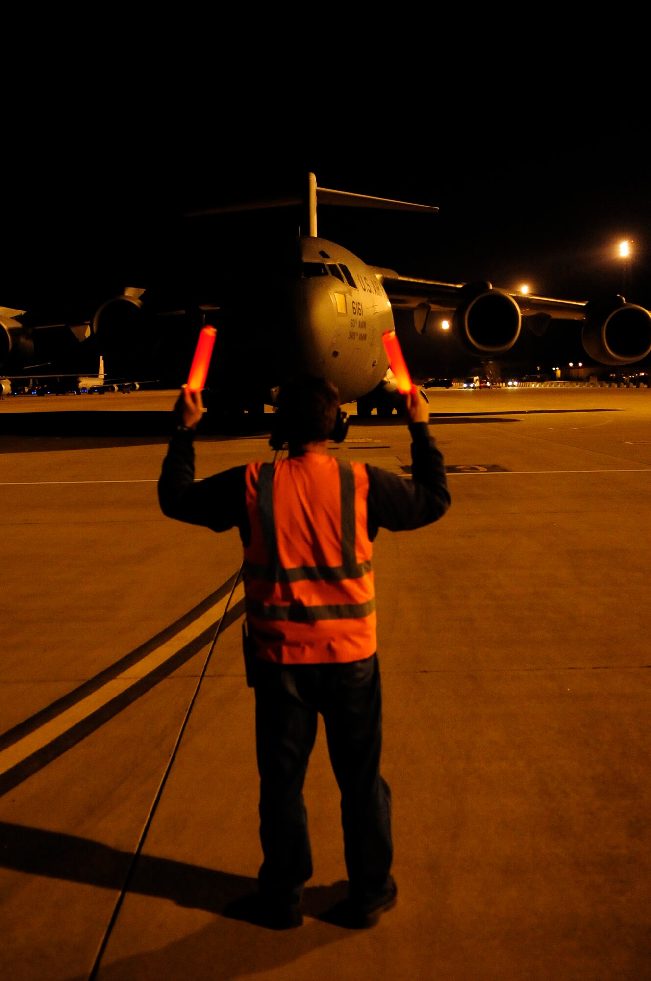 313th AIR EXPEDITIONARY WING (March 28, 2011) -- A C-17 Globemaster III from Travis Air Force Base, Calif., is marshaled into a parking spot on the flightline during support of Joint Task Force Odyssey Dawn. Joint Task Force Odyssey Dawn was the U.S. Africa Command task force established to provide operational and tactical command and control of U.S. military forces supporting the international response to the unrest in Libya and enforcement of United Nations Security Council Resolution (UNSCR) 1973. UNSCR 1973 authorizes all necessary measures to protect civilians in Libya under threat of attack by Gadhafi regime forces. JTF Odyssey Dawn was commanded by U.S. Navy Admiral Samuel J. Locklear III. (U.S. Air Force photo/Senior Airman Ethan Morgan)