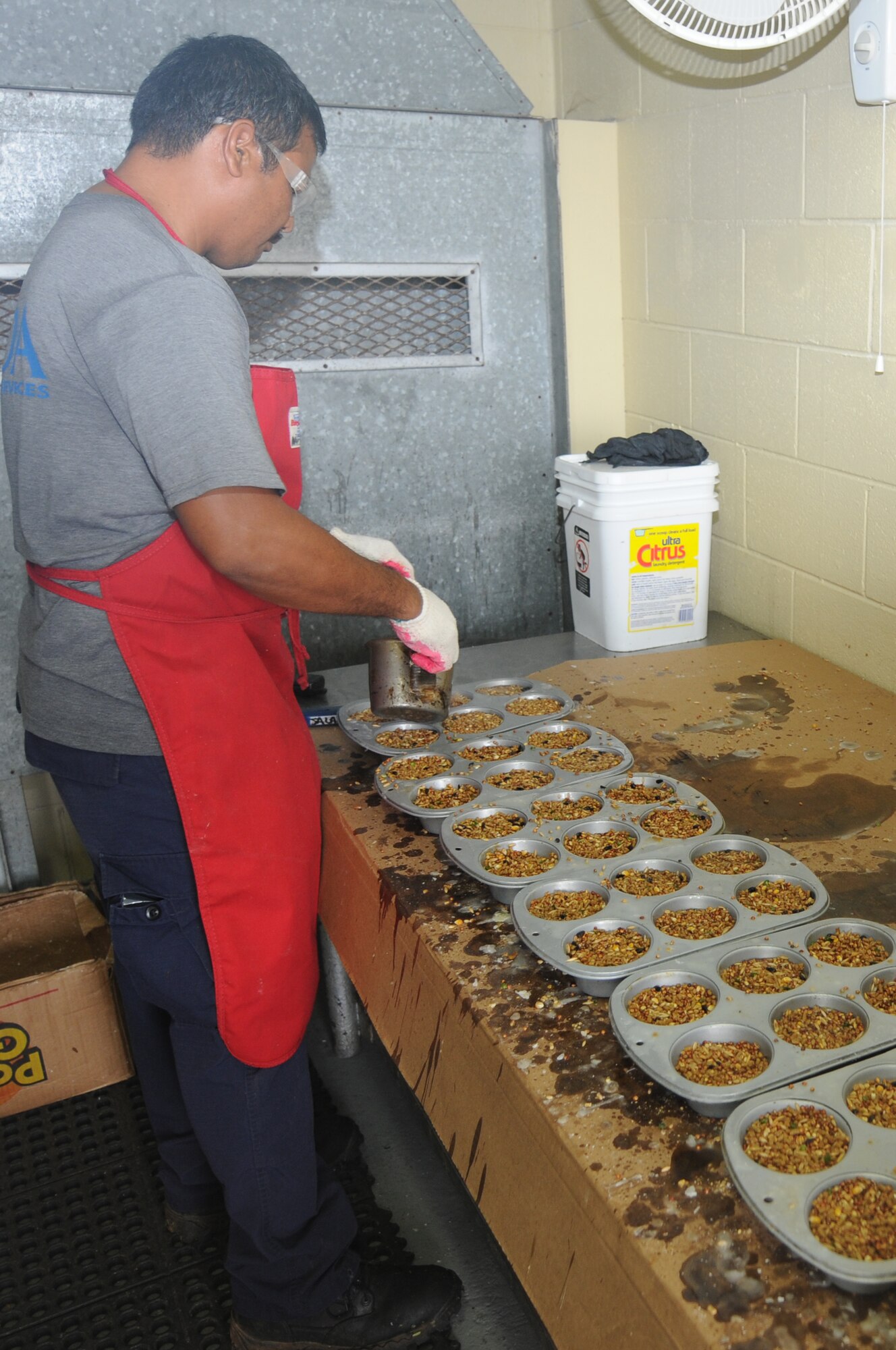 ANDERSEN AIR FORCE BASE, Guam - Frank Reyes, U.S. Department of
Agriculture, cooks up some mice feeding blocks here, March 31. The
feed blocks consist of regular chicken feed and are used to feed the mice
that are within the brown tree snake traps. The mice are considered
government mice and are kept safe from the snake entering the trap by a
protective barrier. (U.S. Air Force photo/ Senior Airman Carlin Leslie)
