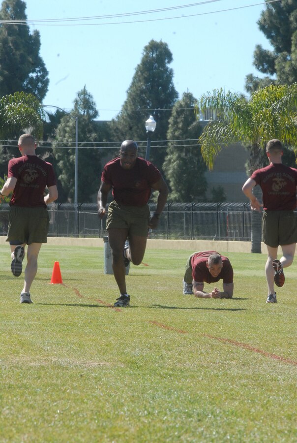 Marines from the Career Planners Course paired up in two-man teams, one teammate would sprint to the opposite side of the field, while the other stayed in a plank position during an intense physical training session at the Semper Fit Center April 1.