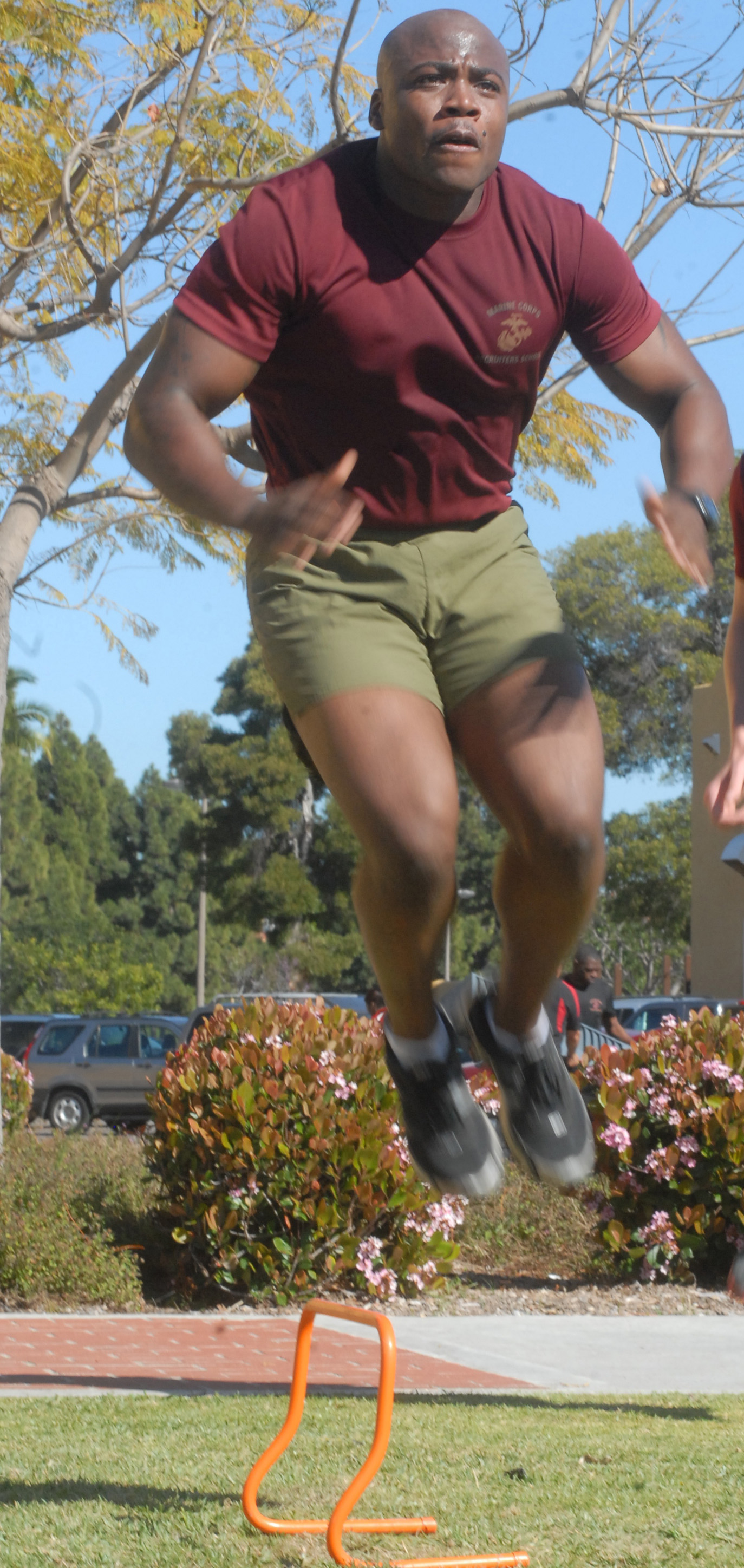 Sgt. Omar B. Askew, a student from Career Planners Course, jumps over small hurdles before doing leg and ammo can lifts during a high-intensity workout April 1.