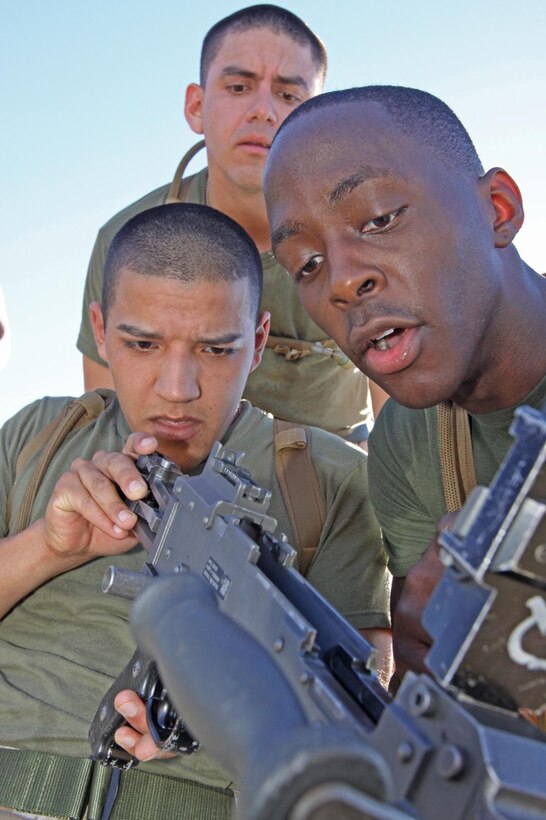 Lance Cpl. John Garcia, administrative clerk, Headquarters and Support Company, School of Infantry – West  finishes reassembling a 240G as part of a quarterly exercise called the “Axe Challenge” in which SOI - W sections compete for bragging rights and a three-foot battle axe. Challenges of the event include a stretcher carry, a combat memory game and the assembly and disassembly of a 240G machine gun.