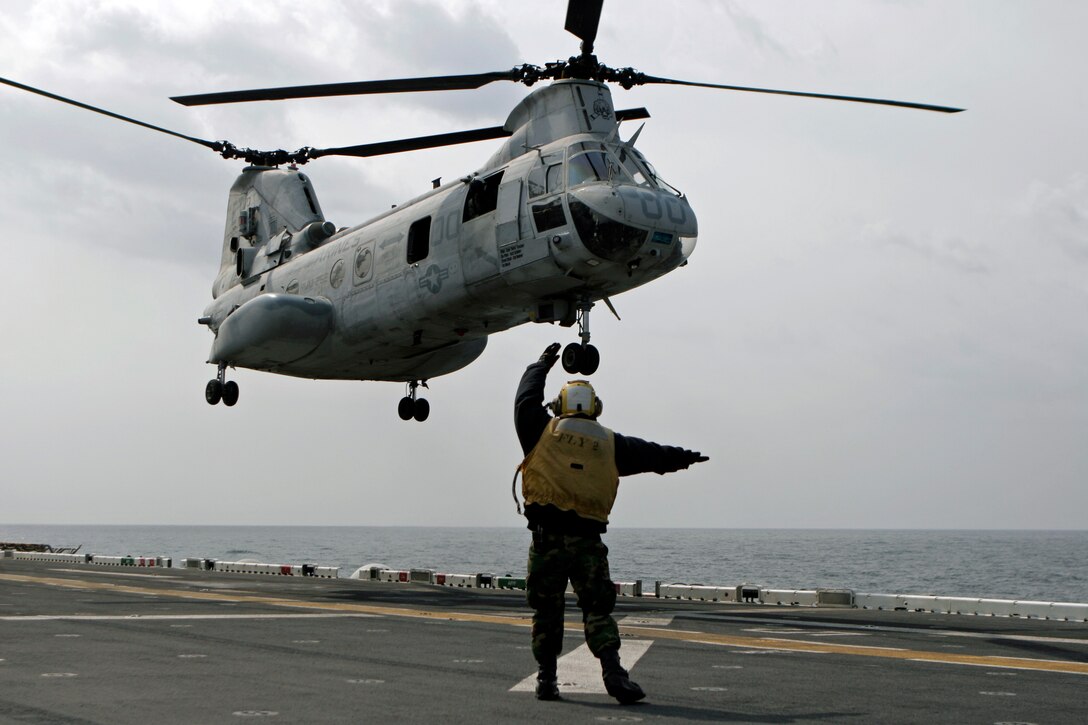 A Sailor with USS Essex (LHD 2) Amphibious Ready Group, directs a CH-46E Sea Knight helicopter as it takes off, April 2. The helicopter, with Marine Medium Helicopter Squadron 262 (Reinforced), 31st Marine Expeditionary Unit, was flying in support of humanitarian aid and disaster relief operations during Operation Tomodachi. The 31st MEU’s involvement is part of a larger U.S. government response, after a 9.0 earthquake and subsequent tsunami struck Japan causing widespread damage. The 31st MEU is ready to support its Japanese partners and to provide assistance when called upon.
