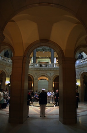 Capt. Jacob C. Aldean, Recruiting Station Twin Cities officer selection officer, calls the audience to attention to start the commissioning ceremony of two Marine Corps officers in the Minnesota State Capitol April 2. For more photos of the event, visit www.facebook.com/rstwincities.