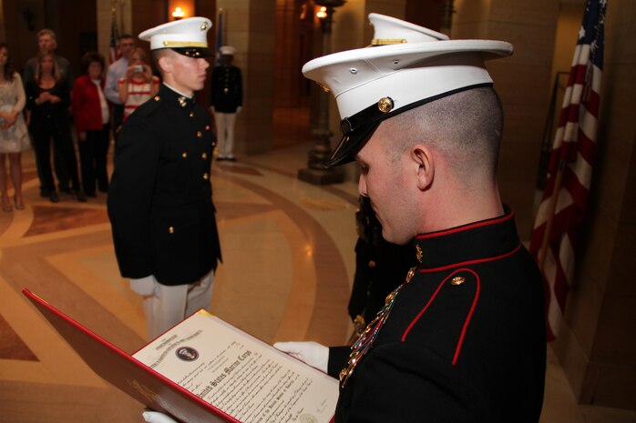 Gunnery Sgt. Roland R. McGinnis, Recruiting Station Twin Cities officer selection assistant, reads 2nd Lt. Tyler A. Kistner's commissioning warrant in the Minnesota State Capitol April 2. Kistner is a 23-year-old Champlin, Minn., native. For more photos of the event, visit www.facebook.com/rstwincities.