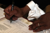 2nd Lt. Marques A. Williams, 24, from St. Paul, Minn., signs his commission papers in the Minnesota State Capitol April 2 after taking the oath of office. For more photos of the event, visit www.facebook.com/rstwincities.
