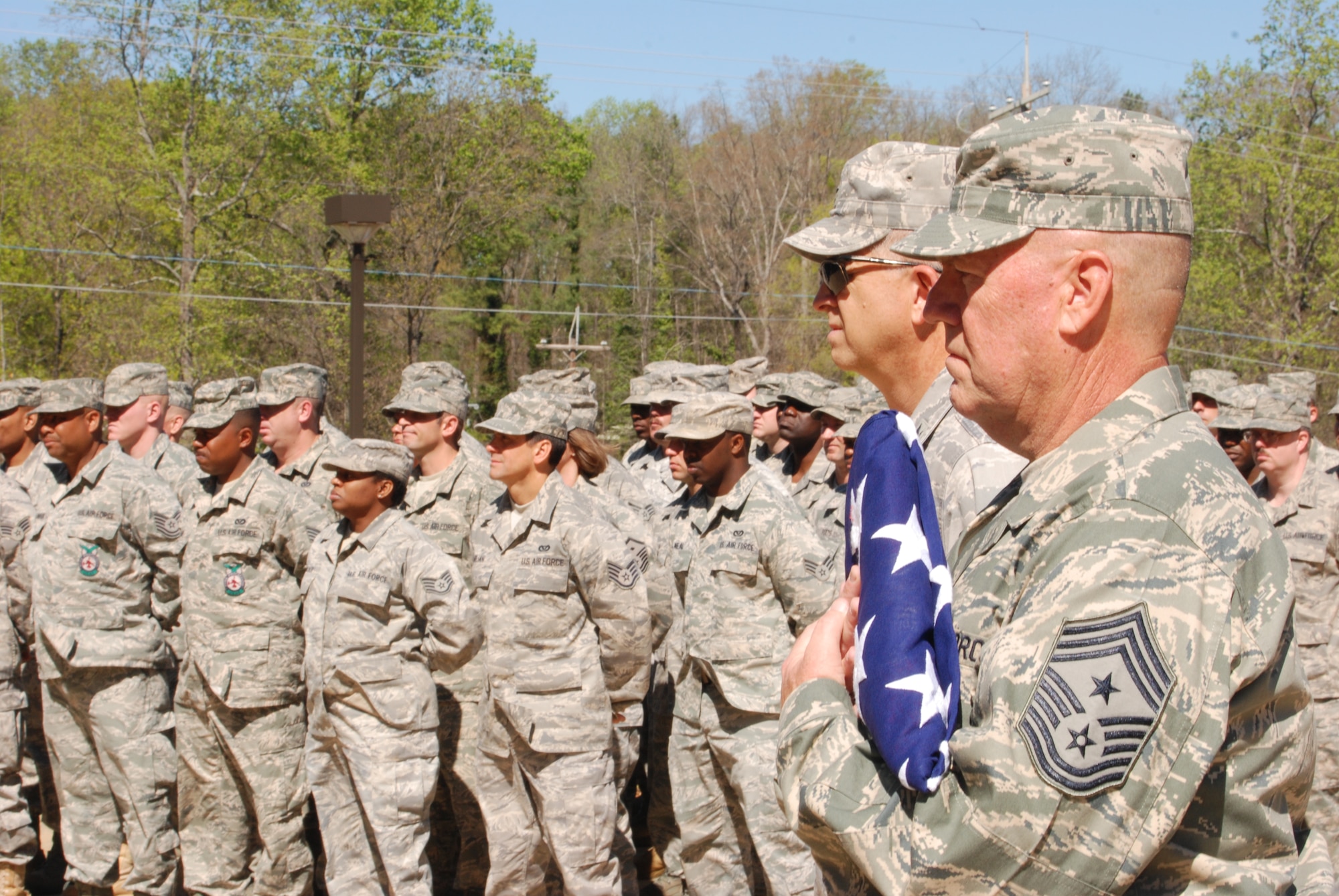 Chief Master Sgt. John Anderson, 94th Airlift Wing Command Chief, displays 33 years of military bearing after receiving the American Flag during a flag folding ceremony performed by the Dobbins Honor Guard.  Chief Anderson accepted the flag in celebration of his final unit training assembly with the 94th Airlift Wing and his retirement.  (U.S. Air Force photo/Master Sgt. Stan Coleman)  