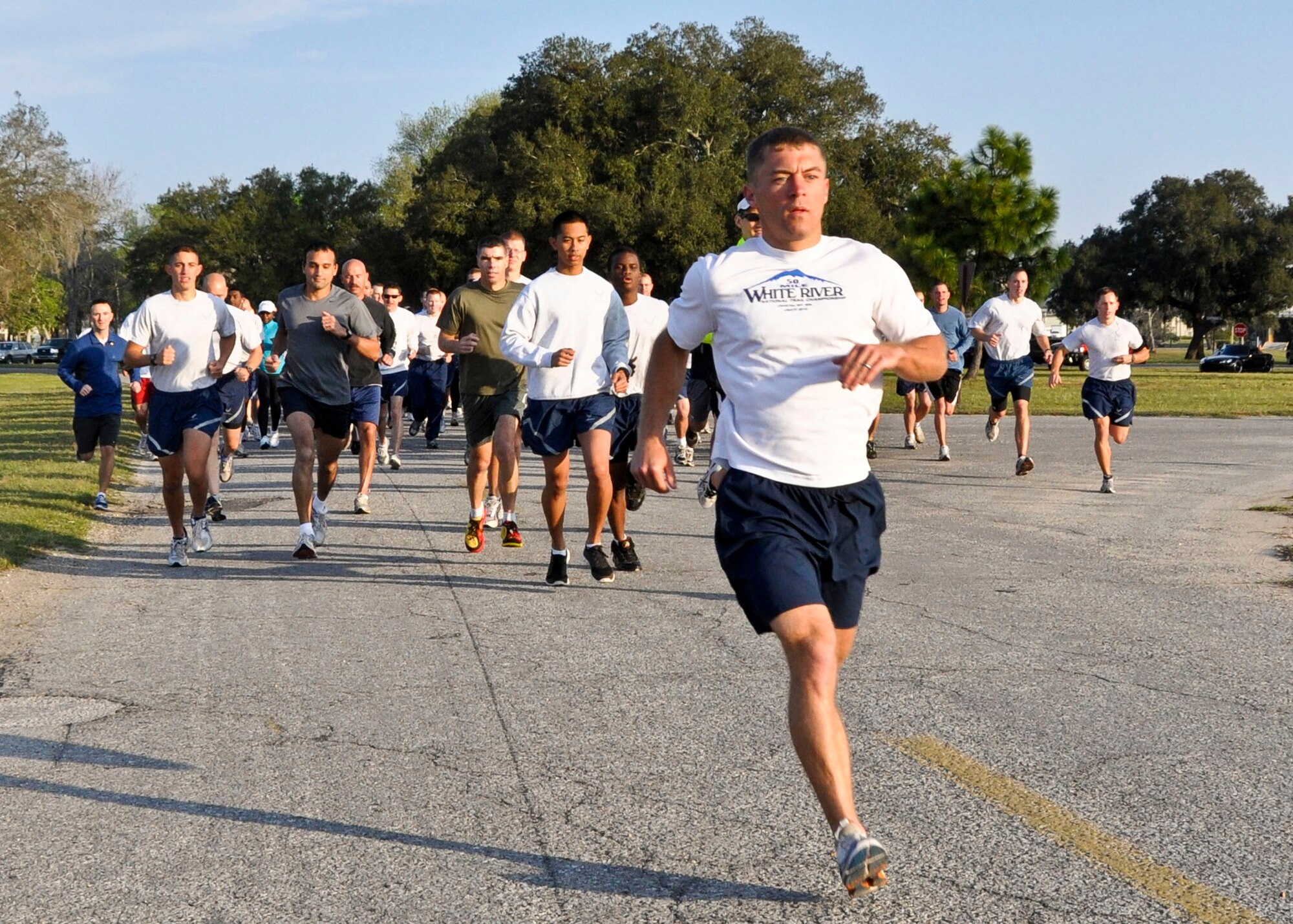 Runners take off at the start of a 5K Fun Run at the Civil Engineering Pavilion April 1, in honor of Sexual Assault Awareness Month. According to the national website, the goal of SAAM is to raise public awareness about sexual violence and to educate communities and individuals on how to prevent sexual violence. The Defense Department theme for the month is "Hurts one. Affects all," which is designed to point out how sexual assault affects not only the victim, but the department as well. The Air Force's slogan supporting the theme is "Real Wingmen Act!" emphasizing the duty of all Airmen to intervene whenever they see questionable behavior. (U.S. Air Force photo/Kevin Gaddie)  