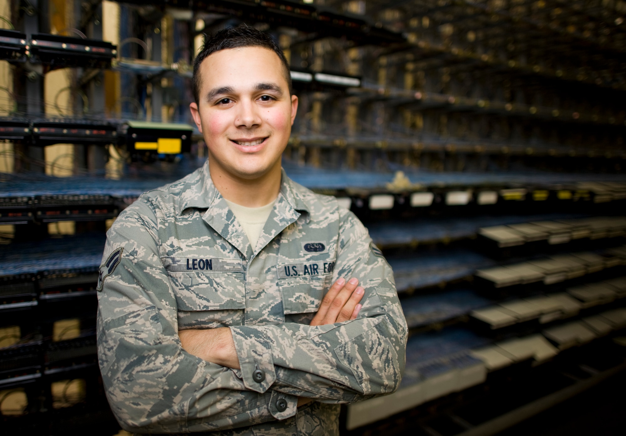 YOKOTA AIR BASE, Japan -- Airman 1st Class Nicholas Leon, 374th Communications Squadron cyber transport technician, stands in the telephone switch room at Yokota Air Base, Japan, April 2, 2011. Airman Leon, a native of Orlando, Fla., helps provide network and telecommunications capabilities for the additional personnel working at Yokota Air Base for Operation Tomodachi. "It feels great to help my counterparts in my host country through this difficult time they're having. It allows me to know I'm completing my mission as well as helping to rebuild their country from the tsunami March 11." (U.S. Air Force photo/Staff Sgt. Samuel Morse)