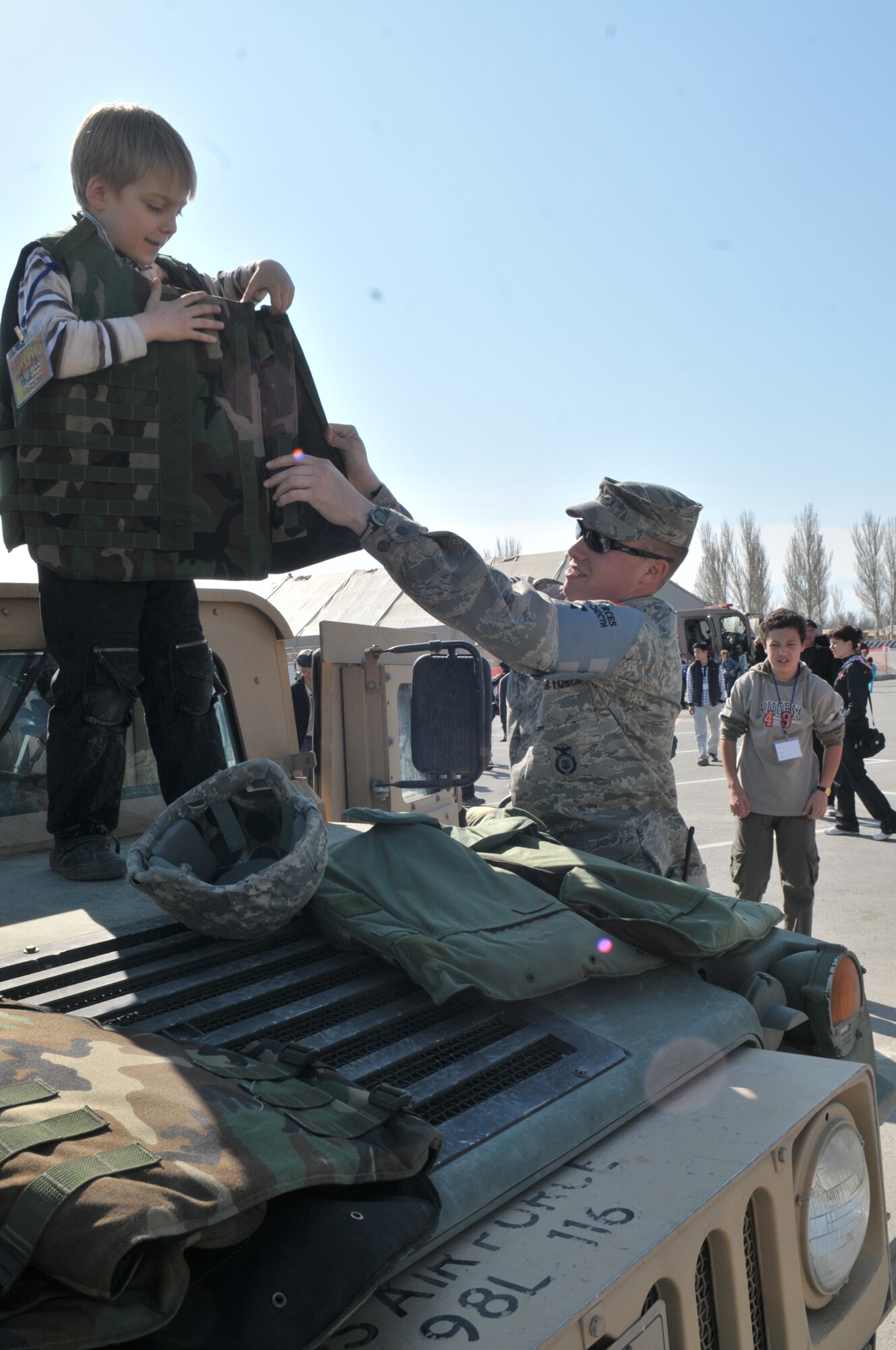 TRANSIT CENTER AT MANAS, Kyrgyzstan - Both Military members and more than 1500 Kyrgyz employees  along with their family members joined in festivities at the Transit Center at Manas Apr. 02.  The Transit Center held a friends and family day that included a barbeque, music, games, K-9 demonstration, and Explosive Ordnance Disposal demonstration. (U.S. Air Force photo/Staff Sgt. Stacy Moless)
