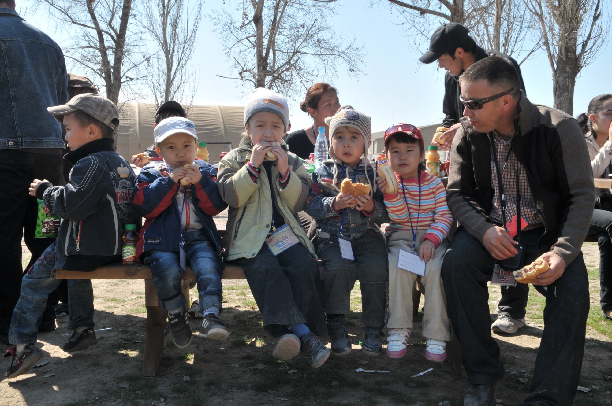 TRANSIT CENTER AT MANAS, Kyrgyzstan - Both Military members and more than 1500 Kyrgyz employees  along with their family members joined in festivities at the Transit Center at Manas Apr. 02.  The Transit Center held a friends and family day that included a barbeque, music, games, K-9 demonstration, and Explosive Ordnance Disposal demonstration. (U.S. Air Force photo/Staff Sgt. Stacy Moless)