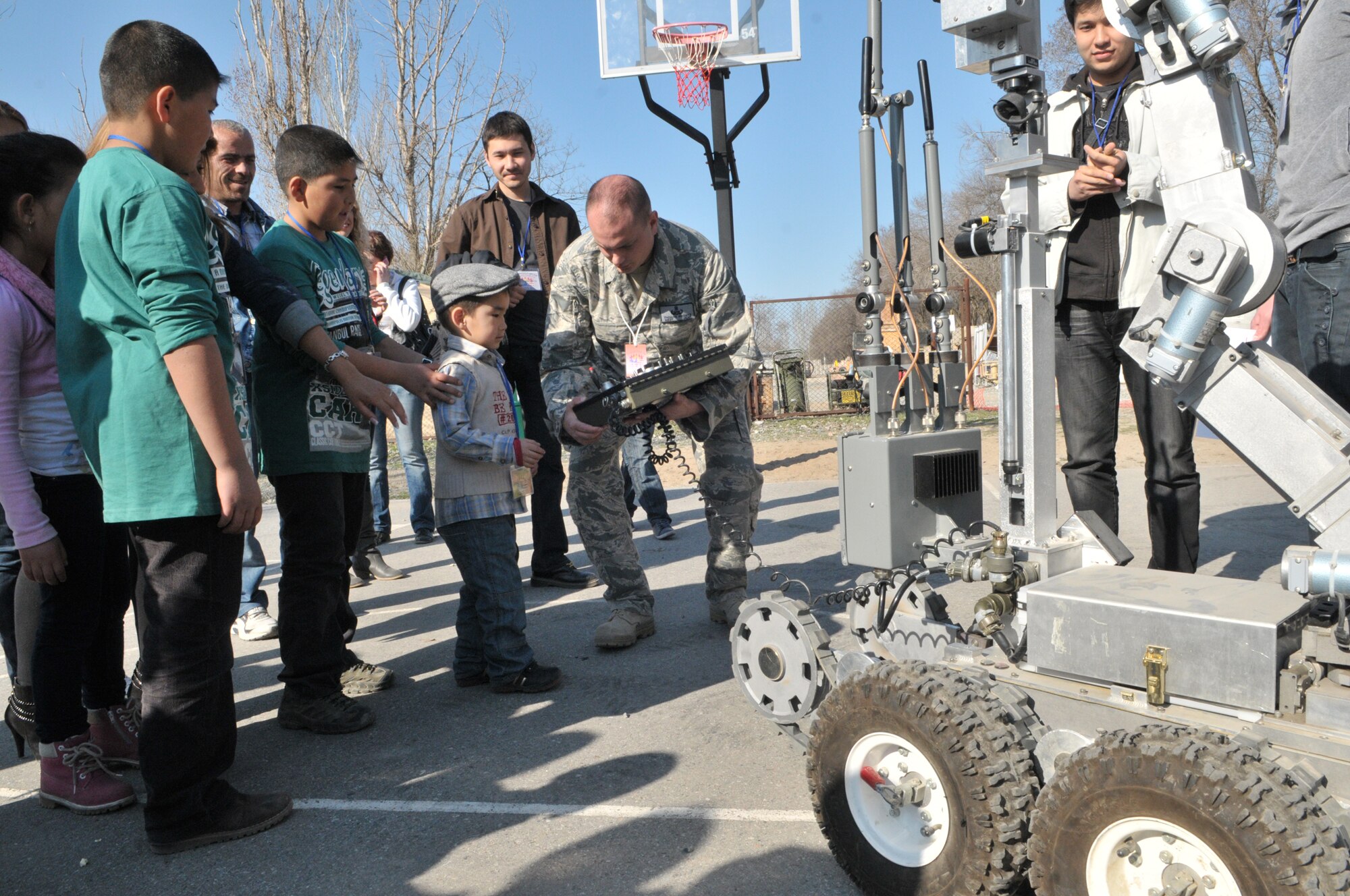 TRANSIT CENTER AT MANAS, Kyrgyzstan - Master Sgt. Tom Koontz  Explosive Ordnance Disposal Technician demonstrates how to use a Andros F6A robot during the Friends and Family day here at the Transit Center at Manas Apr. 02.  The Transit Center held a friends and family day that included a barbeque, music, games, K-9 demonstration, and Explosive Ordnance Disposal demonstration. (U.S. Air Force photo/Staff Sgt. Stacy Moless)