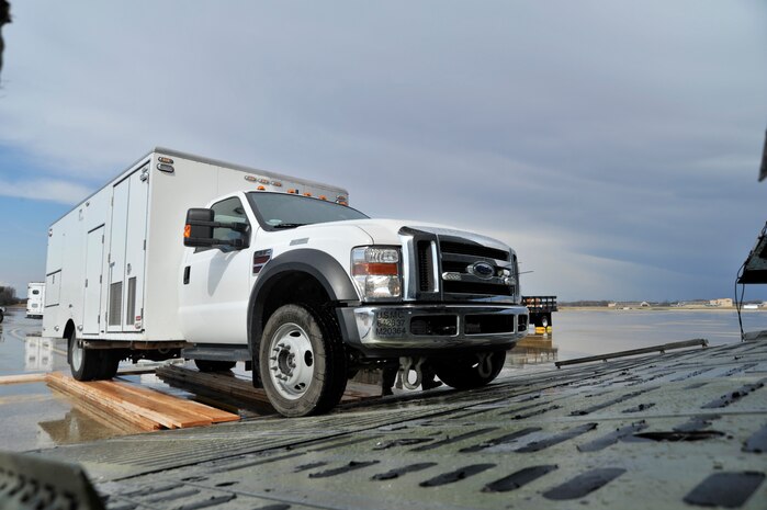 Marines from the II Marine Expeditionary Force, Chemical Biological Incident Response Force, Initial Response Force 'A' load CBIRF response vehicles onto a C-5 Galaxy bound for Japan, Apr. 1, 2011. Based at Naval Suport Facility Indian Head Maryland, CBIRF is a unit comprised of Marines and sailors specially trained to counter the effects of a chemical, biological, radiological, nuclear, and high-yeild explosive (CBRNE) incident. Usually, that intails being available to assist local, state and federal agencies with domestic emergency responses to CBRNE incidents. This is CBIRF's first  overseas deployment since it was stood up in 1996 in response to the sarin attack on Tokyo subway in 1995.(Released)
